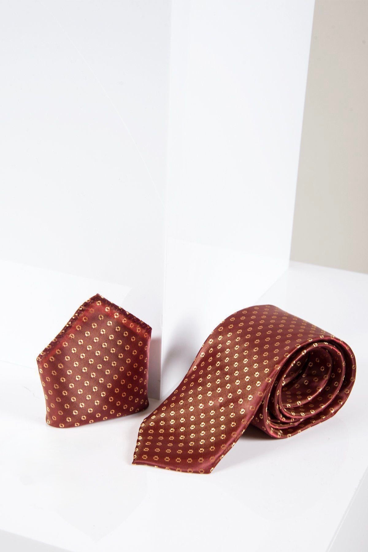 The Marc Darcy TS TUBES set, featuring an orange spot tie and matching pocket square, is displayed on a white geometric surface, offering a refined silk-style texture for an elevated formal look.