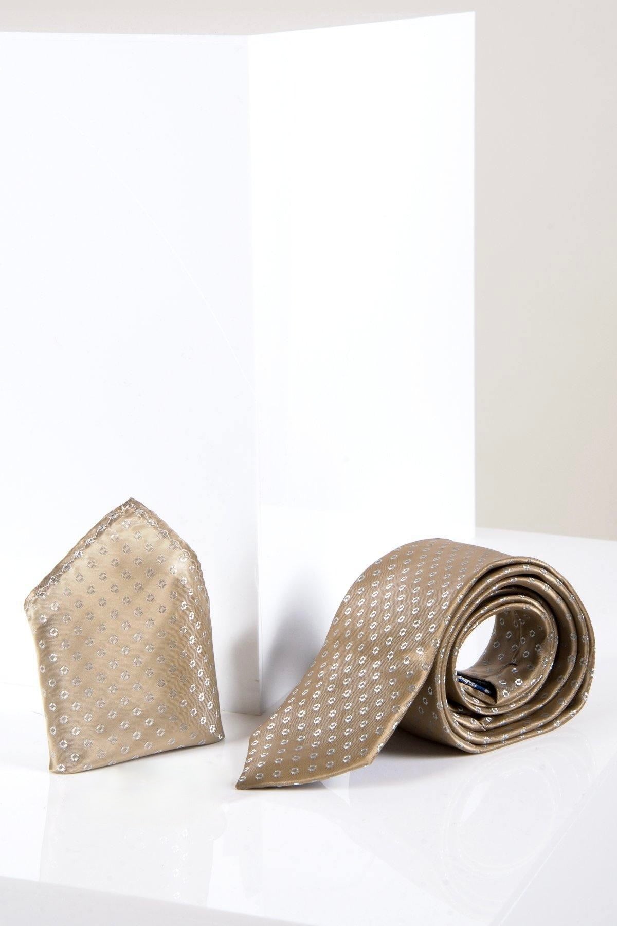 The TS TUBES - Tan Spot Tie and Pocket Square Set by Marc Darcy features a silk-style texture and white dot pattern, shown on a reflective surface with a geometric white background.