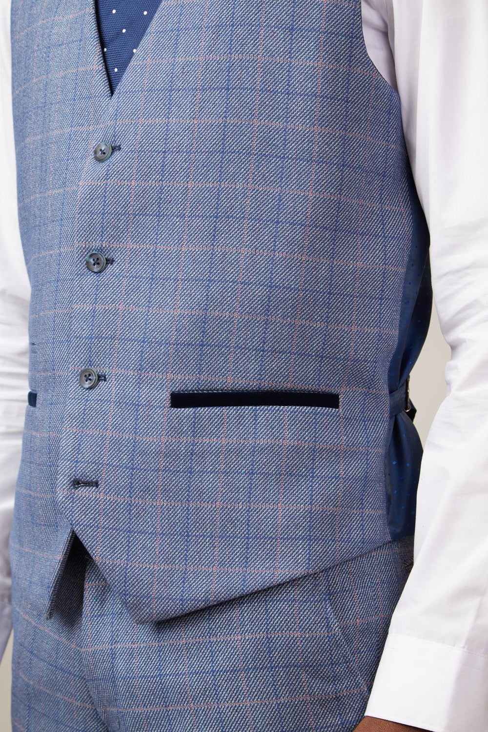 A person wears the marcdarcy HILTON Blue Tweed Check Single Breasted Waistcoat with matching trousers, a white shirt, and navy polka dot tie; the look features subtle red lines, black-trimmed pockets, and vintage flair.