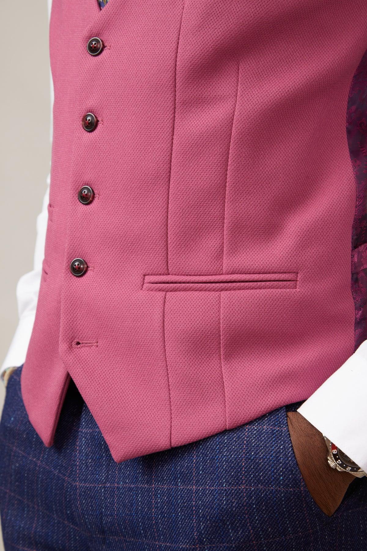 Close-up of a person wearing the marcdarcy KELVIN Berry Single Breasted Waistcoat over a white shirt, paired with blue checkered trousers. The waistcoat features dark buttons, a welt pocket, and a slim fit design. One hand is in the trouser pocket.