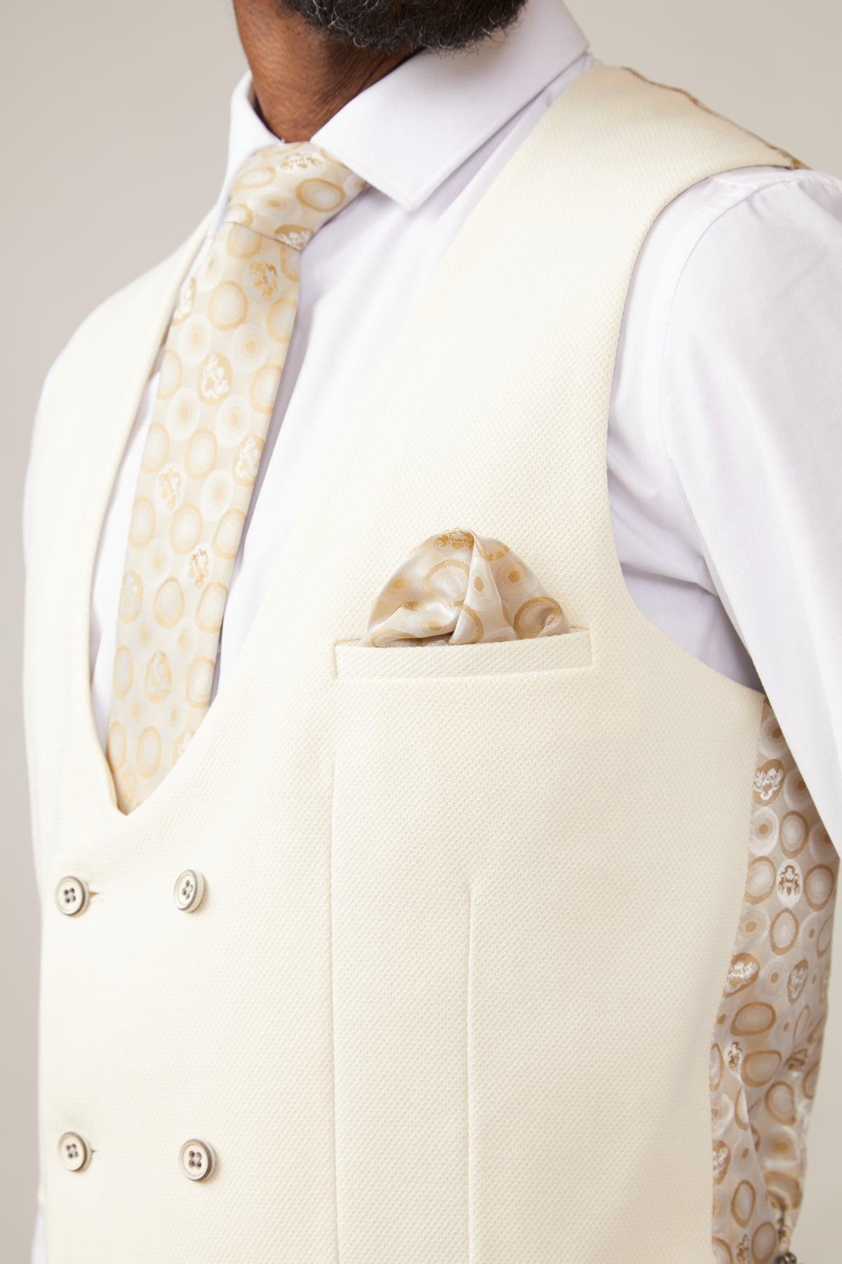A close-up of a man wearing the marcdarcy KELVIN cream double breasted waistcoat, paired with a patterned tie and pocket square, highlighting classic British tailoring.