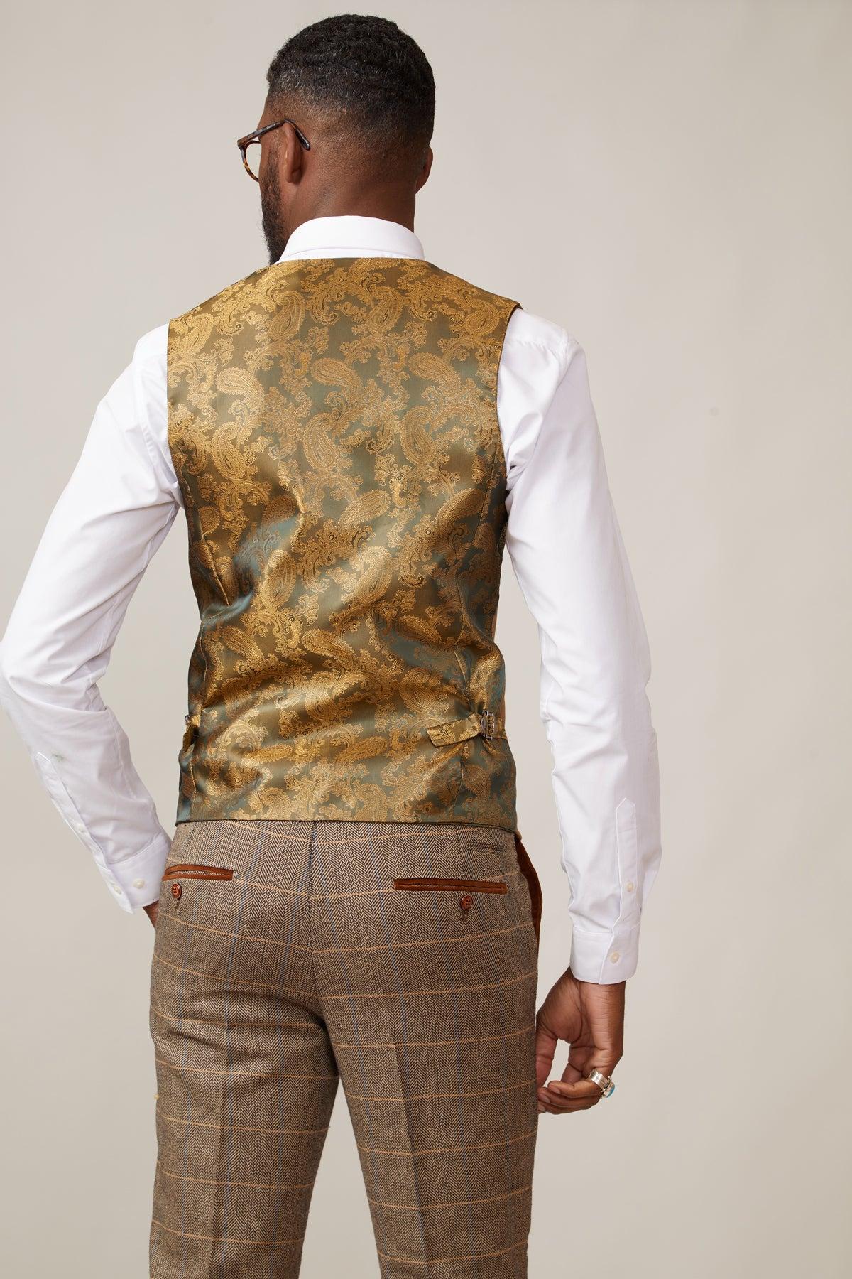 Man wears a white dress shirt, marcdarcy KELVIN - Oak Single Breasted Waistcoat in gold paisley, and brown plaid pants.