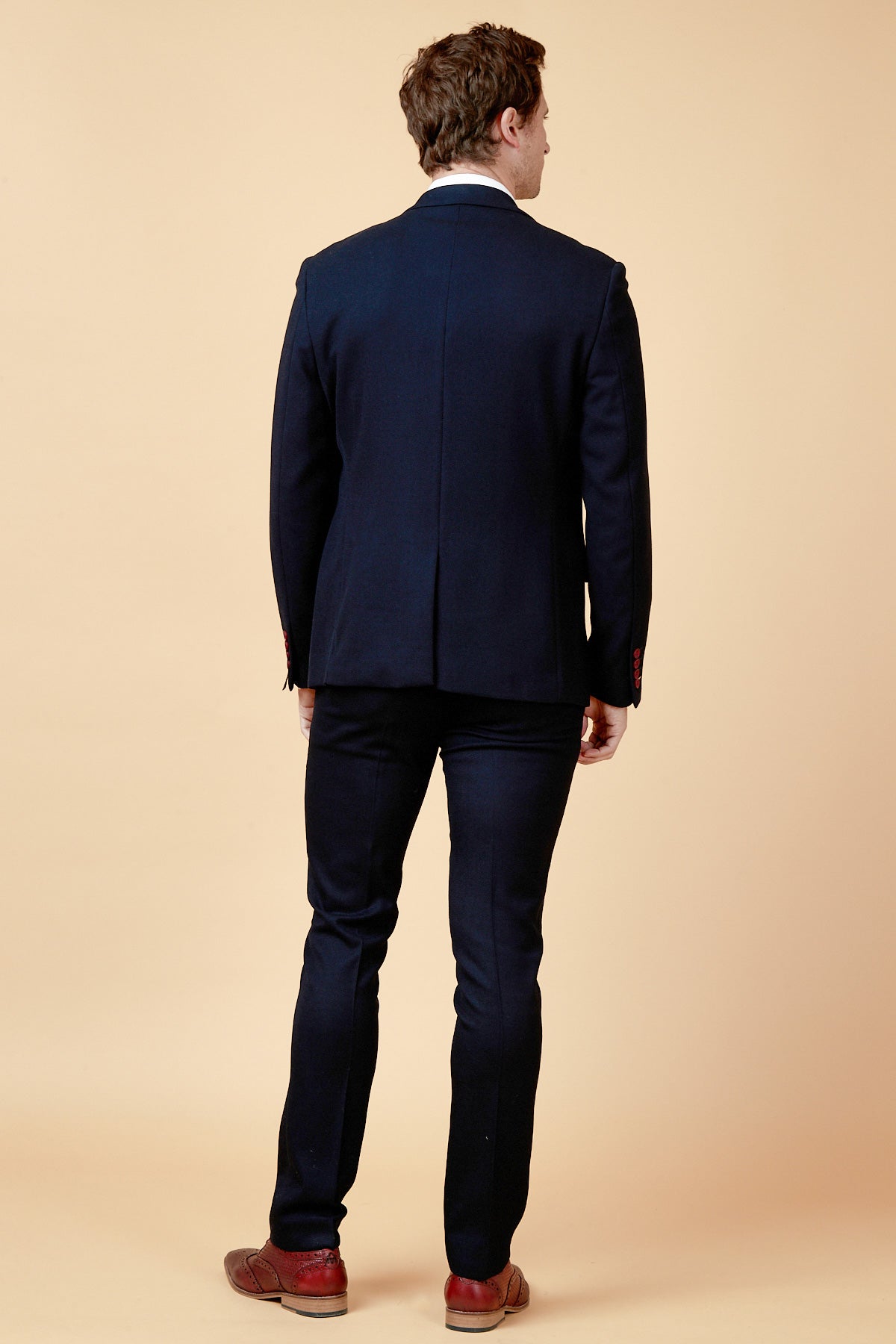 A man with short brown hair, seen from behind against a light beige background, models the marcdarcy JD4 - Navy Contrast Trim Three Piece Suit—ideal for a stylish wedding guest.