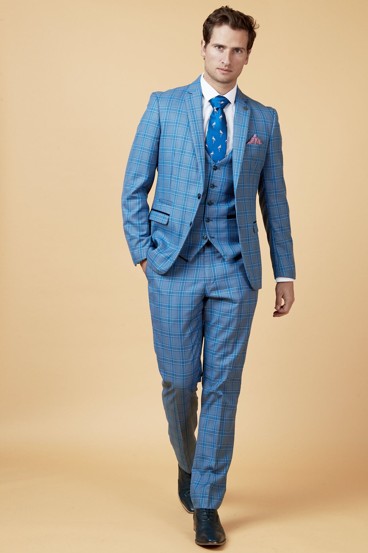 Man in a marcdarcy JOSE Sky Blue Check Three Piece Suit, styled with a flamingo tie and pink pocket square.