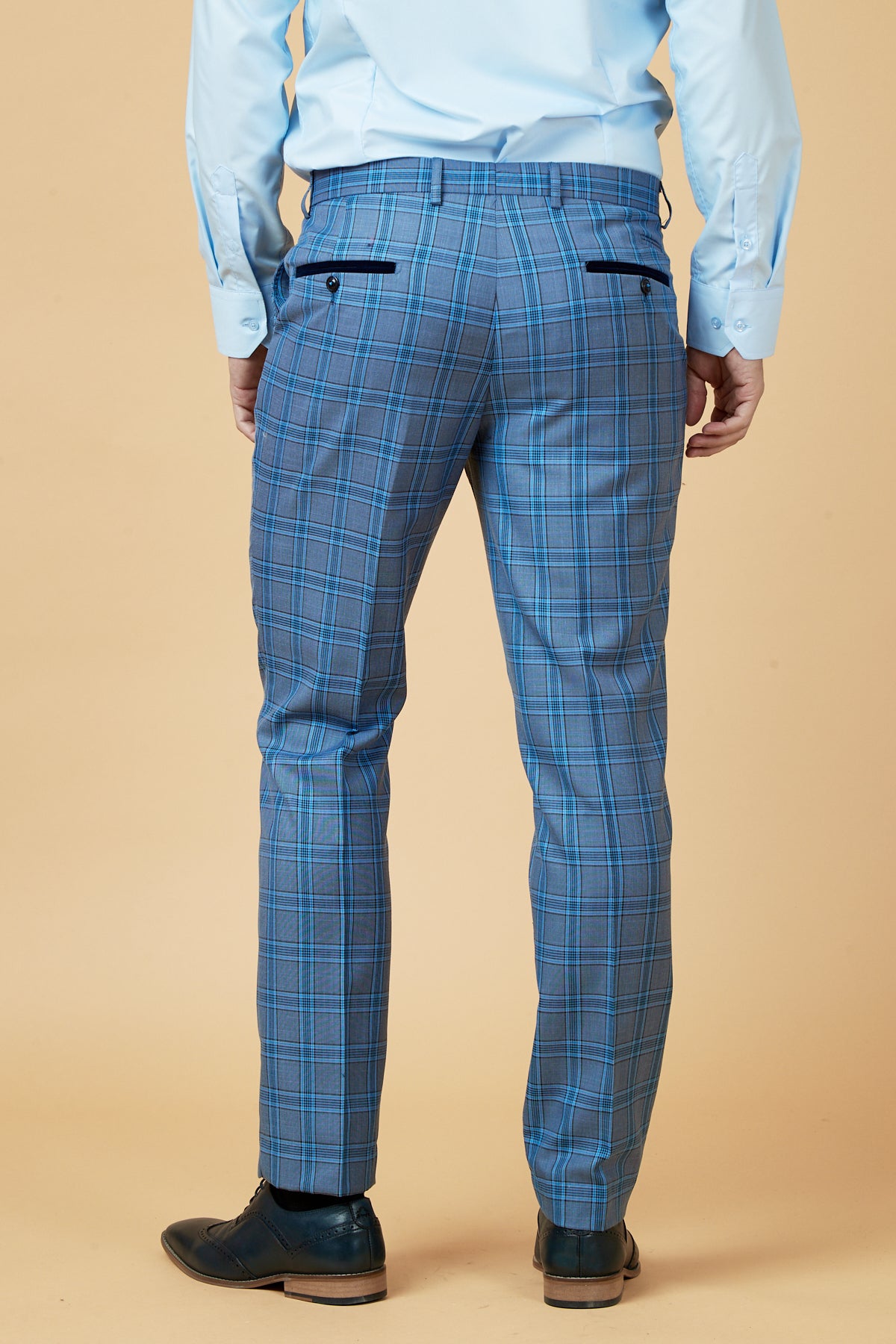 A person wearing the marcdarcy JOSE - Sky Blue Check Three Piece Suit stands facing away against a beige background.
