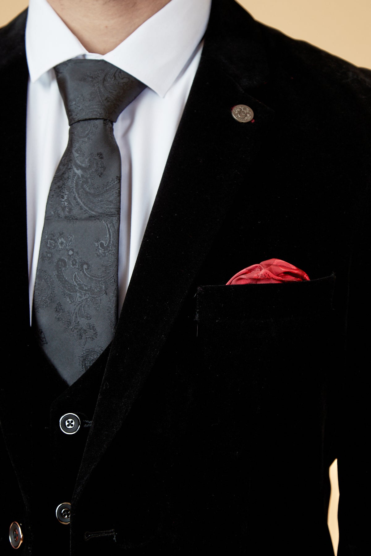 A person wears the marcdarcy HUDSON Black Velvet Blazer with a white dress shirt, black patterned tie, and red pocket square, shown from shoulders to chest.