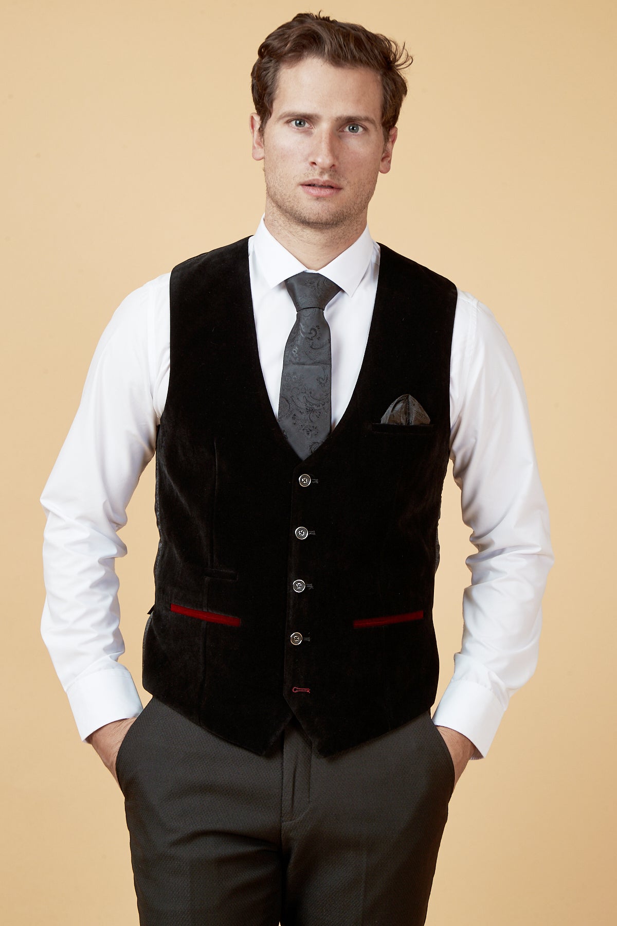A man wearing a white dress shirt, grey patterned tie, grey patterned trousers, and the marcdarcy HUDSON - Black Velvet Jacquard Waistcoat.