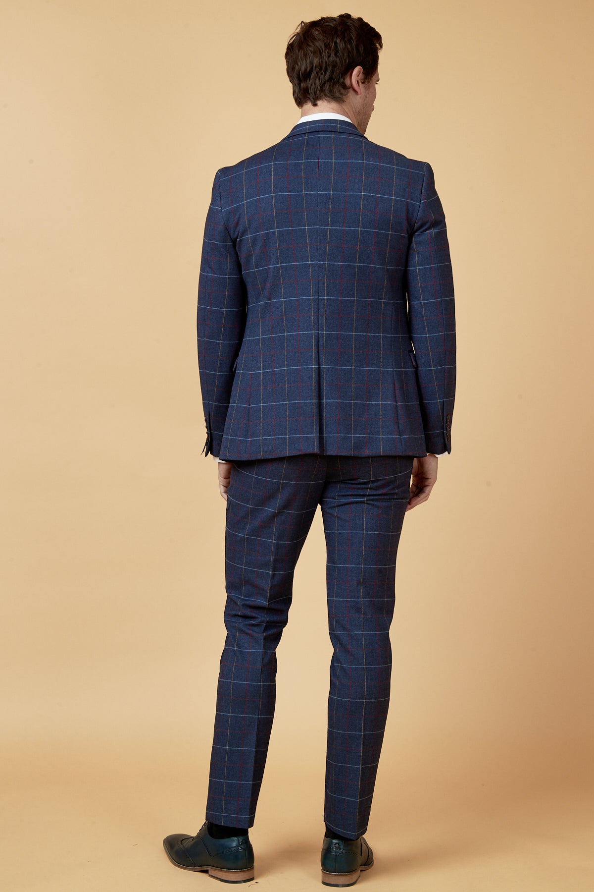 Back view of a man wearing the marcdarcy DRAKE Navy Check Three Piece Suit, paired with a white shirt and dark dress shoes.