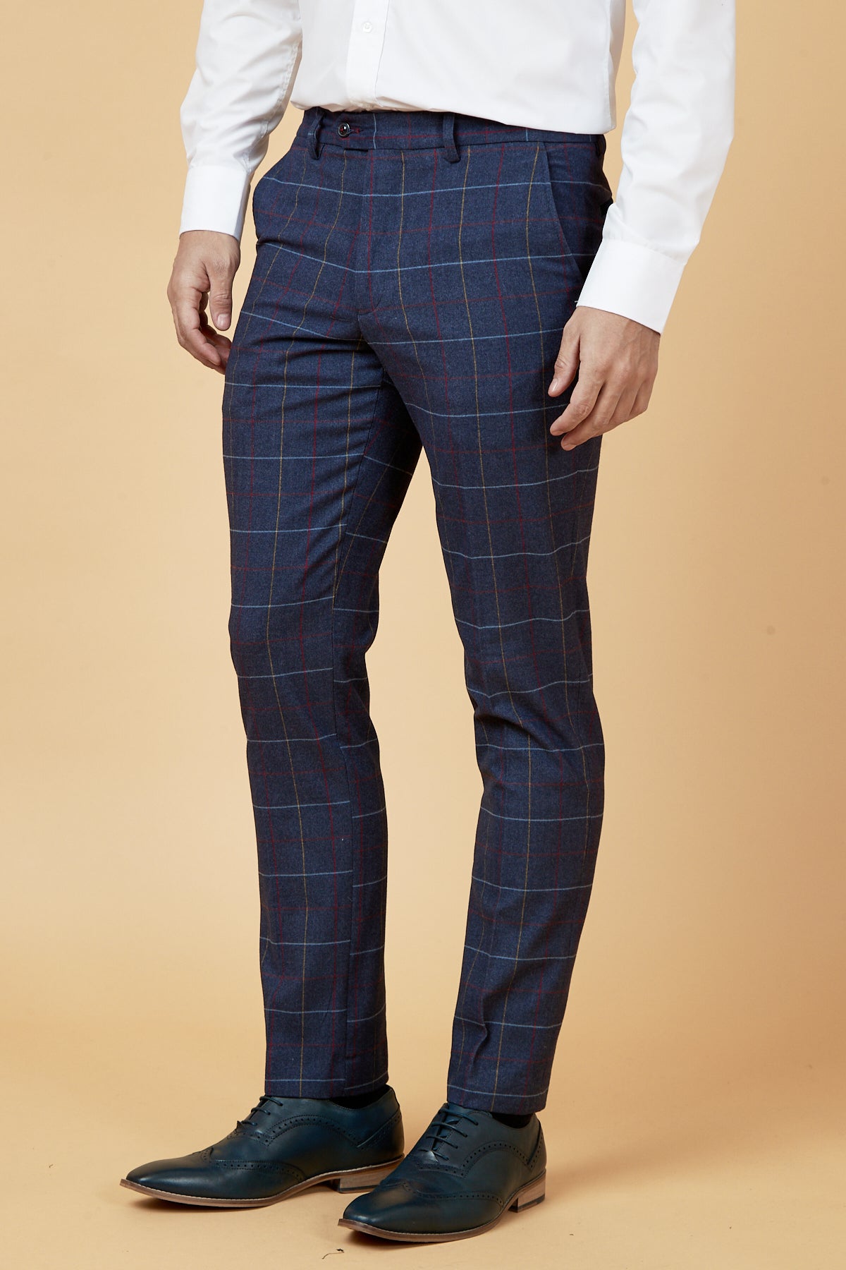 A man wearing a marcdarcy DRAKE Navy Check Three Piece Suit stands against a beige background.