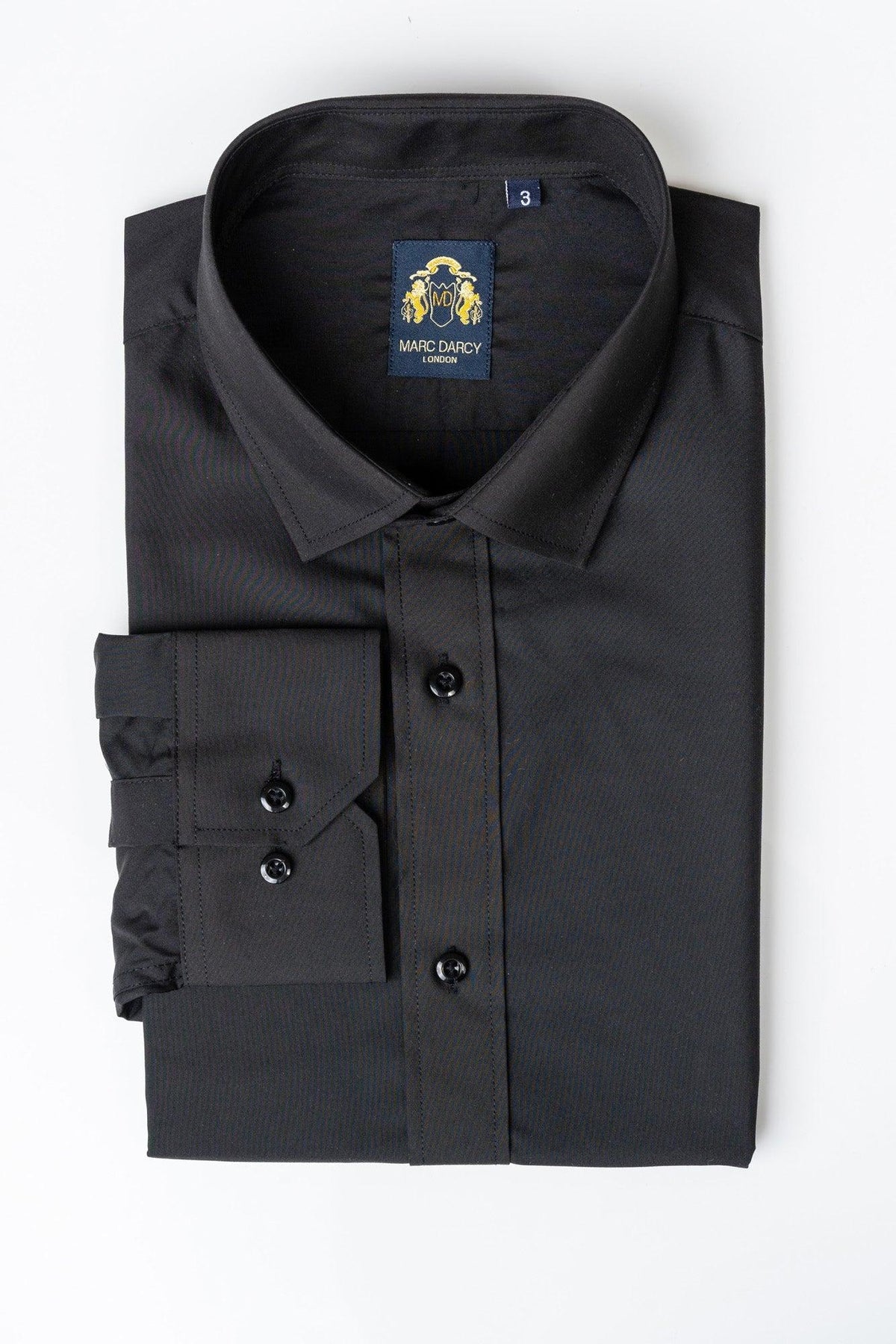 The CARTER Black Long Sleeve Shirt by Marc Darcy features black buttons, classic fit, and a visible Marc Darcy label inside the collar, shown neatly folded on a white background.