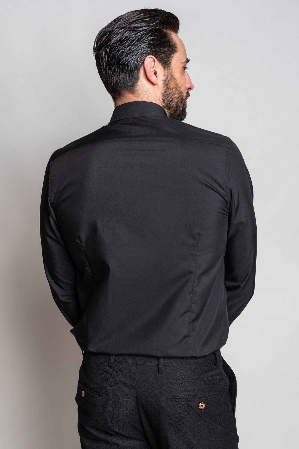 Back view of a man wearing the Marc Darcy CARTER black long sleeve shirt paired with patterned black pants.