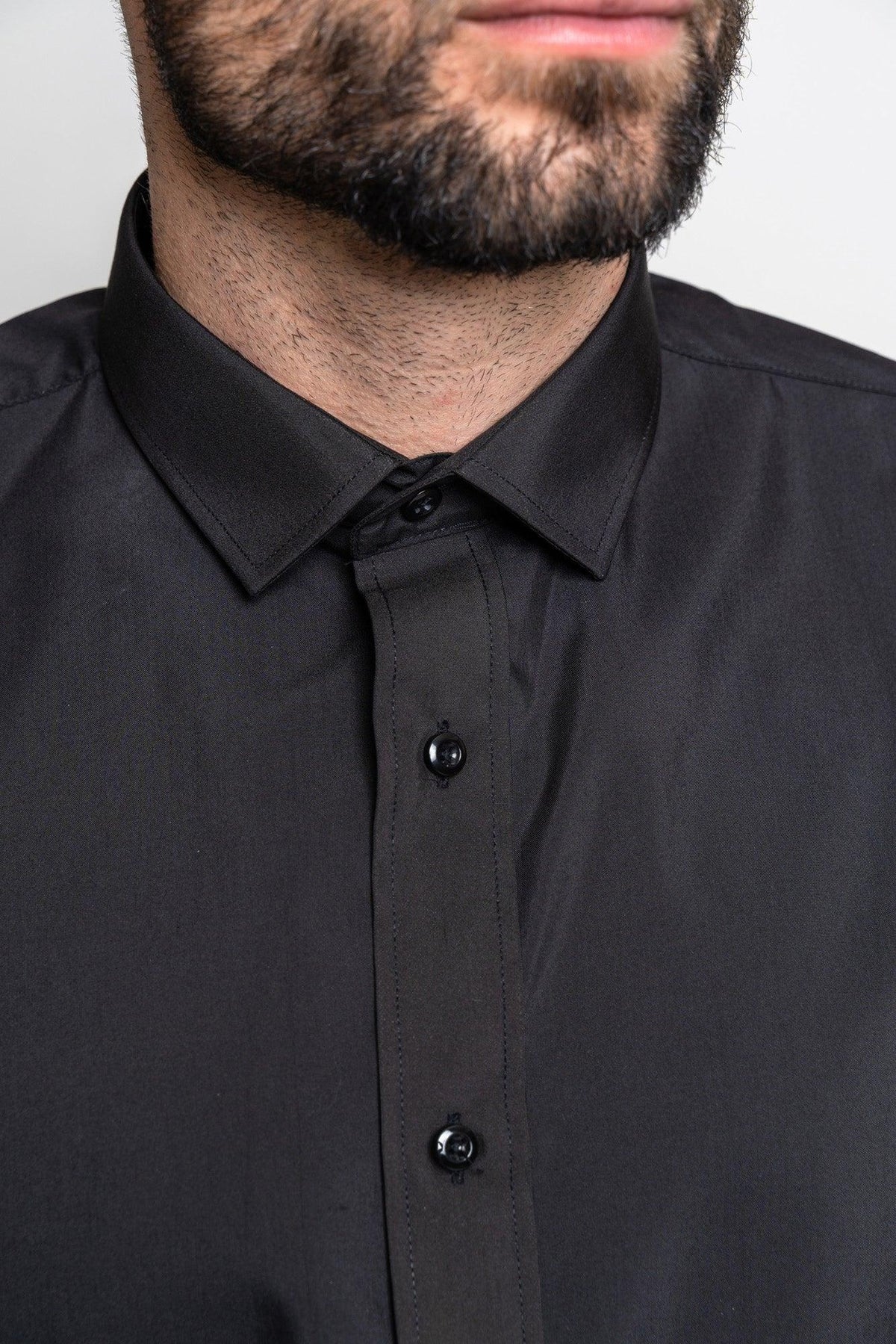 A close-up shows a man in the Marc Darcy CARTER black long sleeve shirt with a spread collar, his neatly trimmed beard and mustache partly visible, emphasizing the classic fit and sharp tailoring.