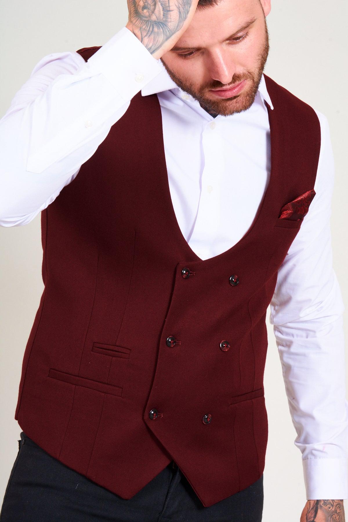 A man wears the marcdarcy KELLY Wine Double Breasted Waistcoat over a white shirt, finished with a patterned pocket square.