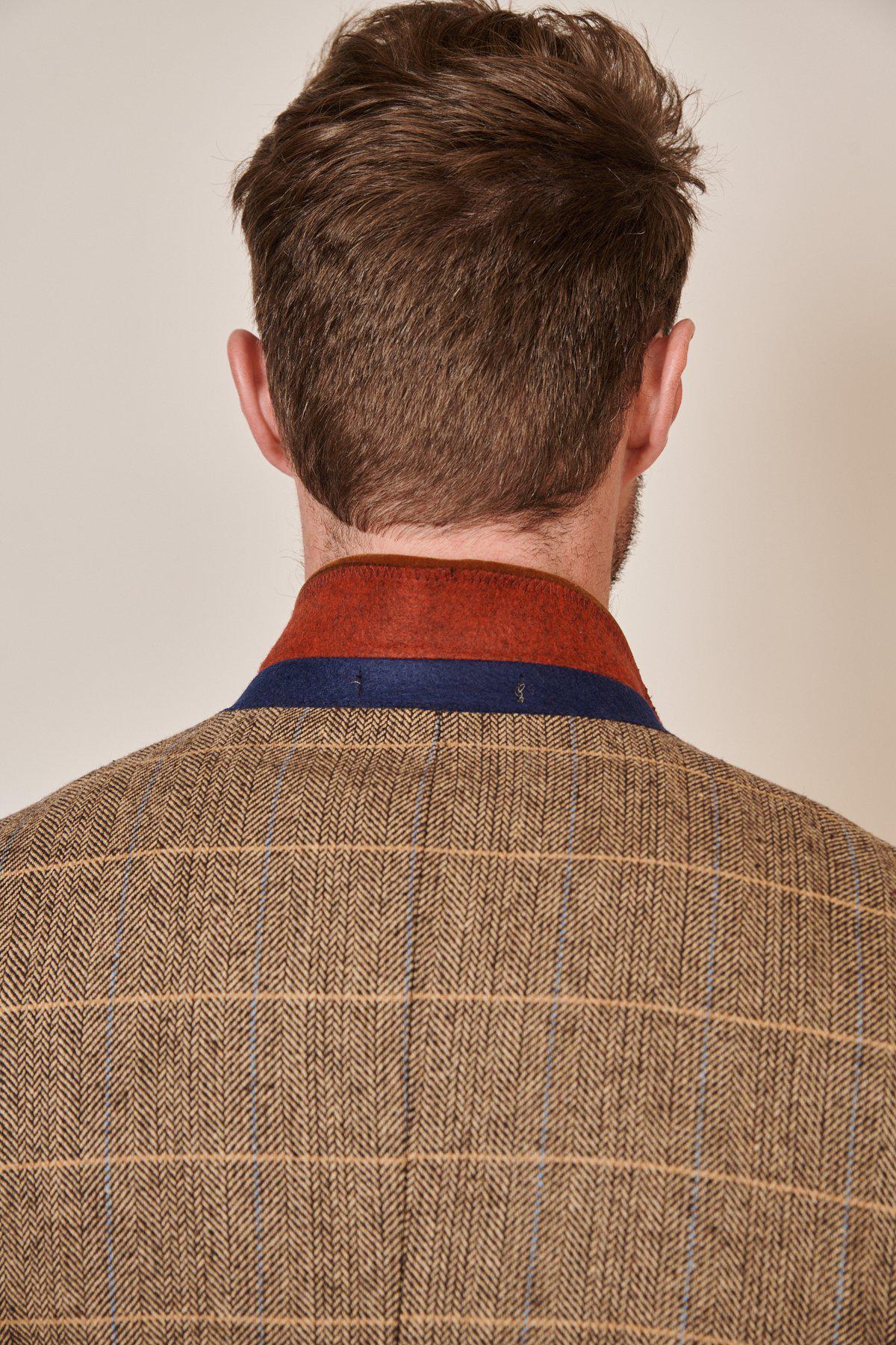 A man is seen from behind wearing the marcdarcy Blogger Style | DX7 Suit as worn by Jonny Hammond, featuring a brown plaid blazer with a velvet collar and red-blue accents, revealing the back of his head and neck.