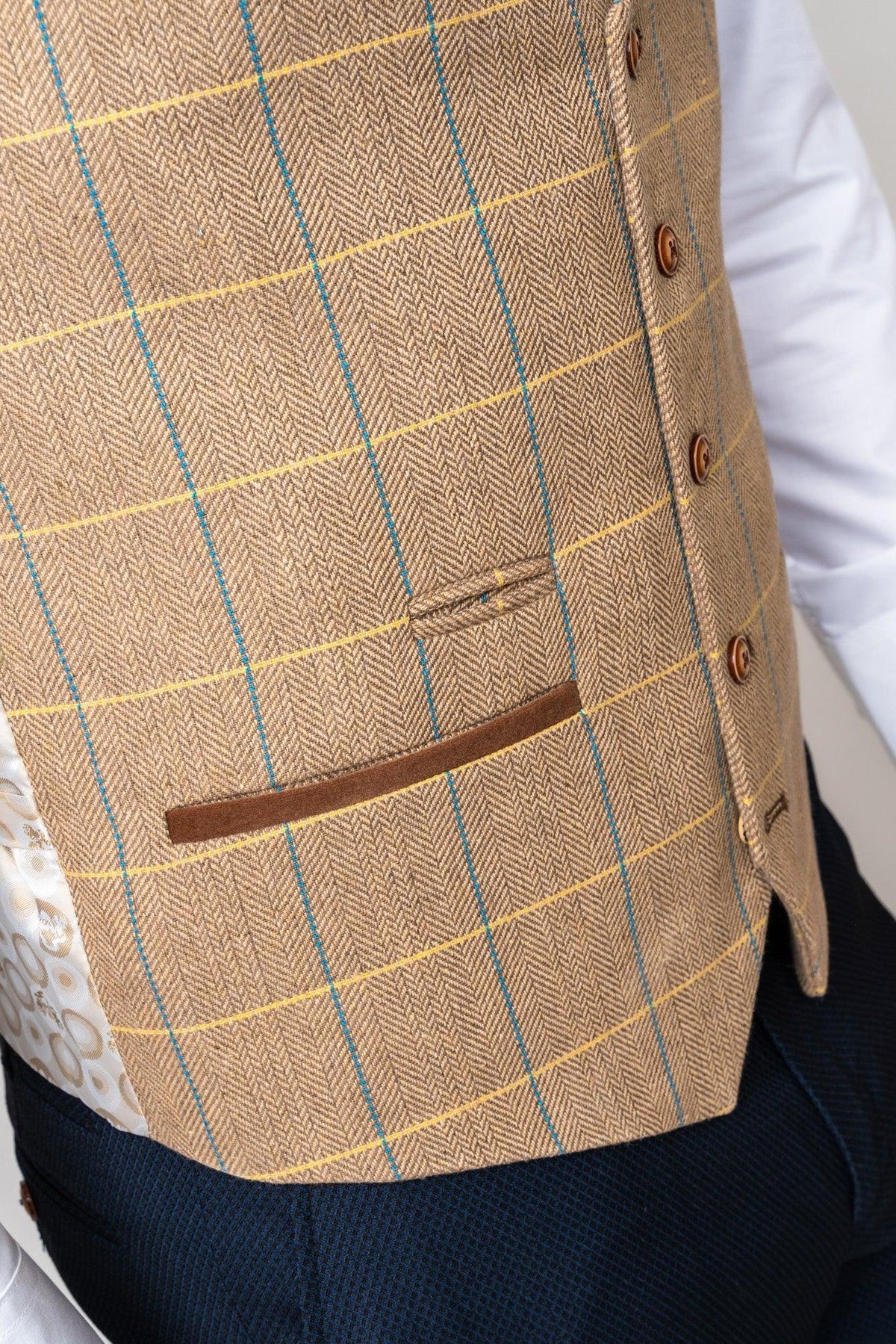Close-up of the marcdarcy DX7 - Oak Tweed Check Waistcoat, a brown heritage-style slim fit with yellow and blue plaid lines and single breast pocket trimmed with brown suede.