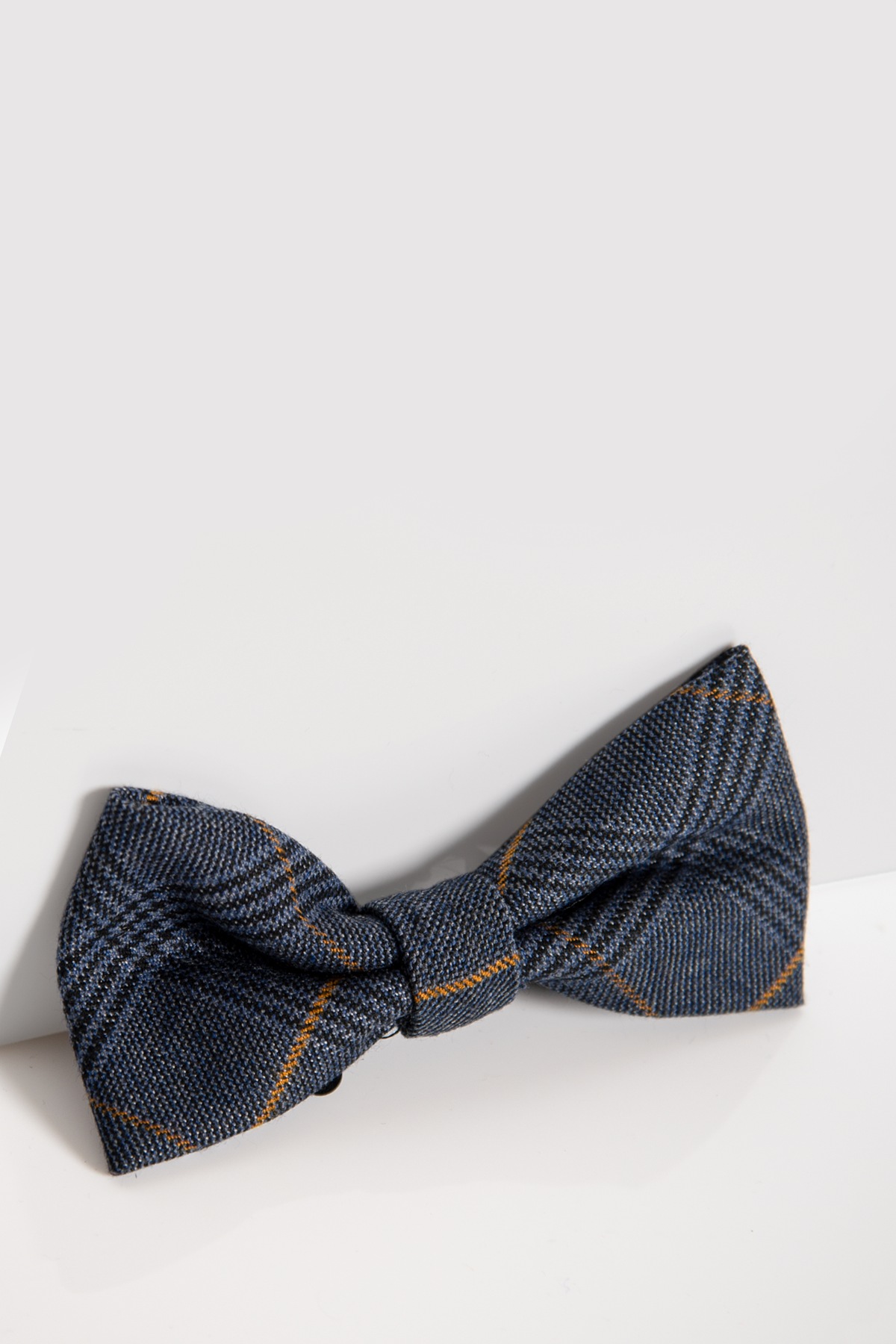 The Marc Darcy JENSON - MARINE NAVY CHECK BOW TIE, featuring a blue and black check pattern with thin orange stripes, is displayed horizontally on a white background.