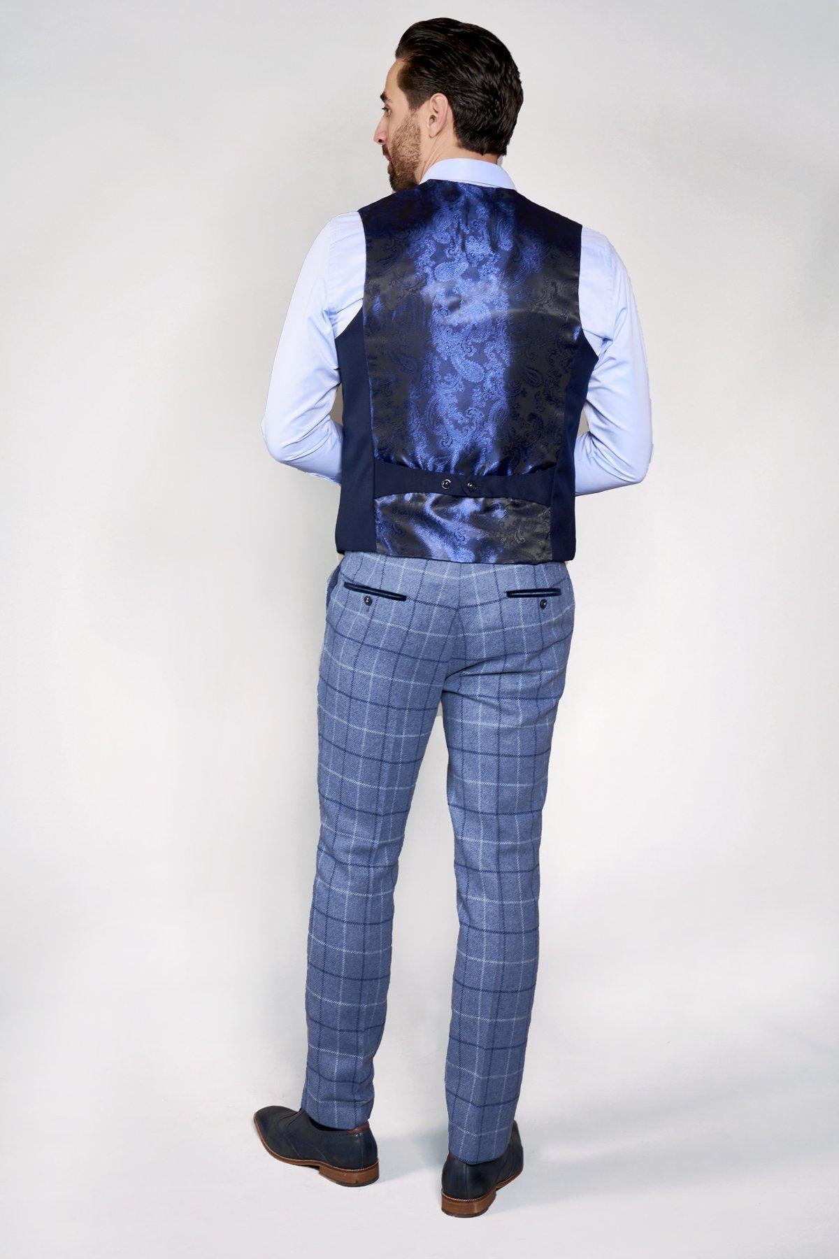 A man seen from the back wears a light blue shirt, blue plaid pants, and the marcdarcy KELLY Blue Single Breasted Waistcoat.