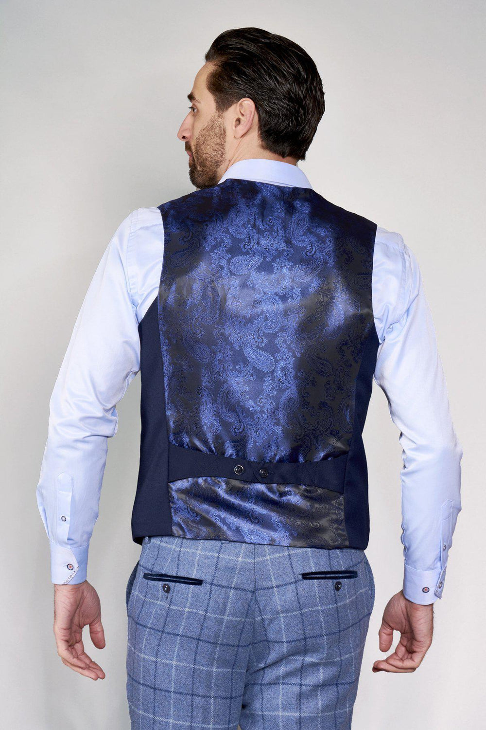 Man wearing a marcdarcy KELLY blue single breasted waistcoat and light blue dress shirt, seen from the back.