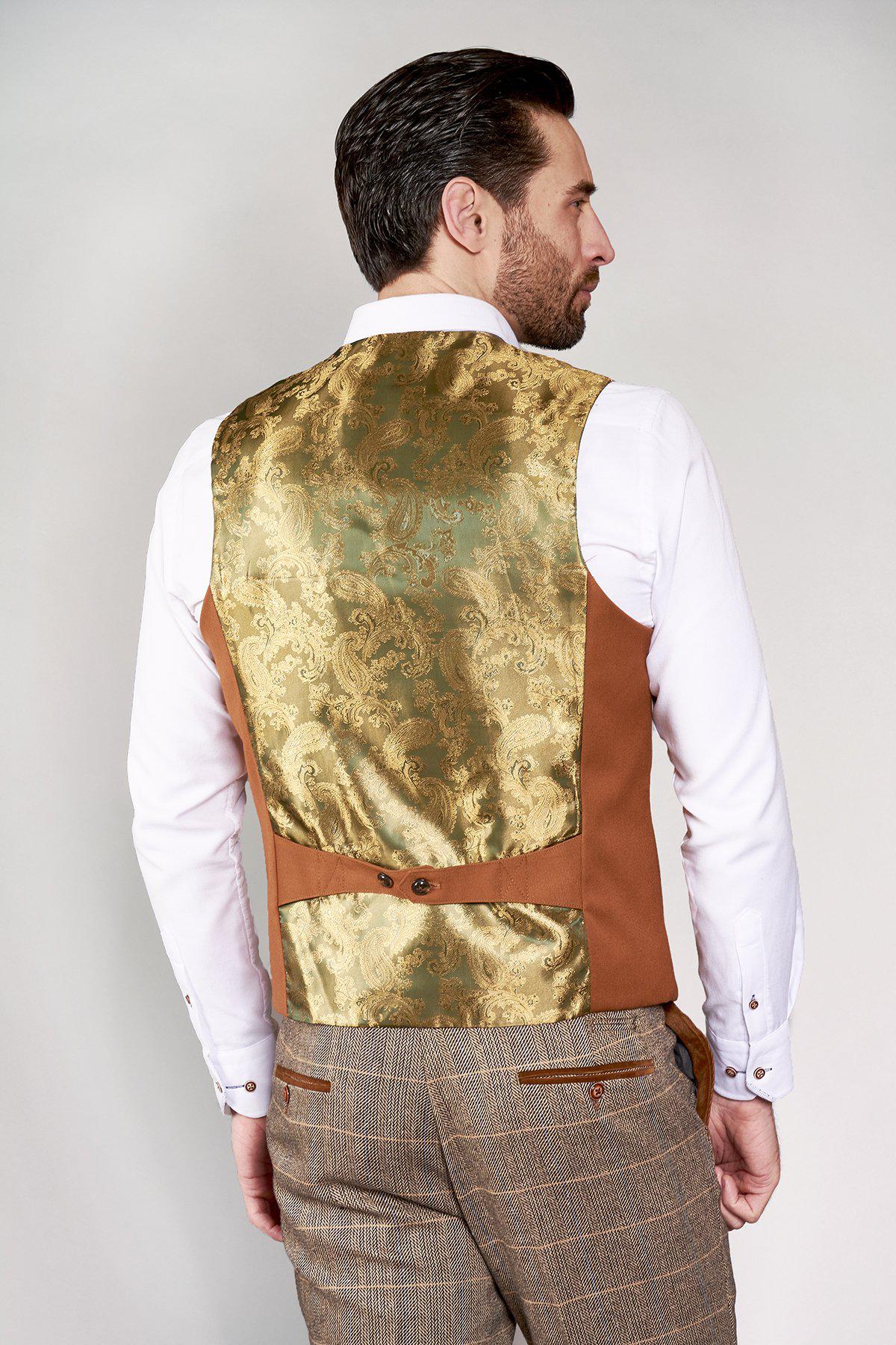 A man seen from behind wears a white shirt, brown plaid trousers, and the marcdarcy KELLY - Dark Tan Single Breasted Waistcoat featuring an ornate gold paisley lining and adjustable strap.