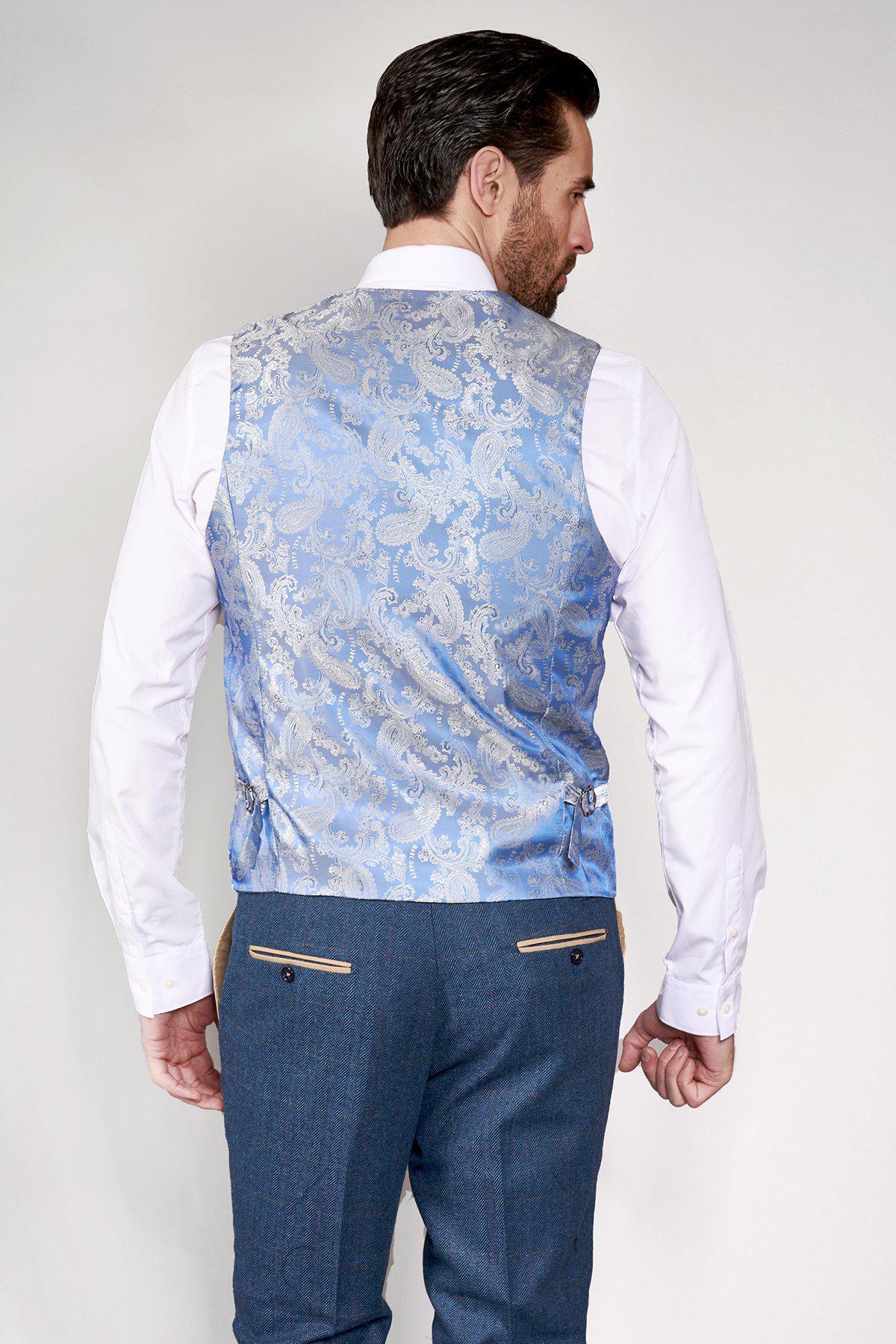 A man is seen from behind in the marcdarcy DION Blue Tweed Check Suit with a Kelvin Stone waistcoat—an elegant, modern groom ensemble featuring subtle checks over a crisp white shirt and blue trousers.