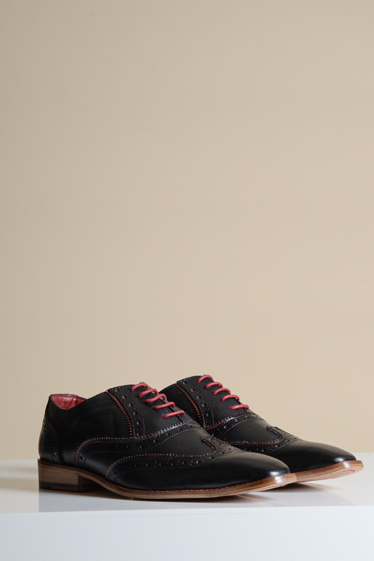 The MARCO Black Bordeaux Leather Wingtip Oxford Shoe by Marc Darcy features full grain leather, red laces, and stitching for a stylish update on classic men’s dress shoes.