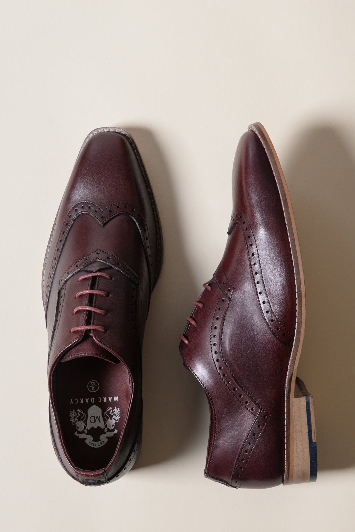 The Marc Darcy DAWSON - Bordeaux Burgundy Wingtip Oxford Brogue Shoes with brown laces are displayed on a light beige background.