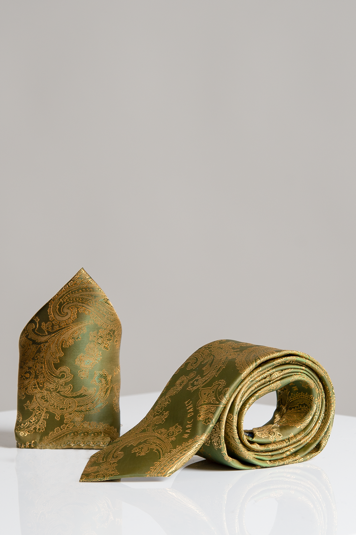 The Accessory MD PAISLEY Tan Paisley Tie and Pocket Square Set features a coordinated tan paisley print tie and pocket square, displayed side by side on a white surface with a neutral gray background.