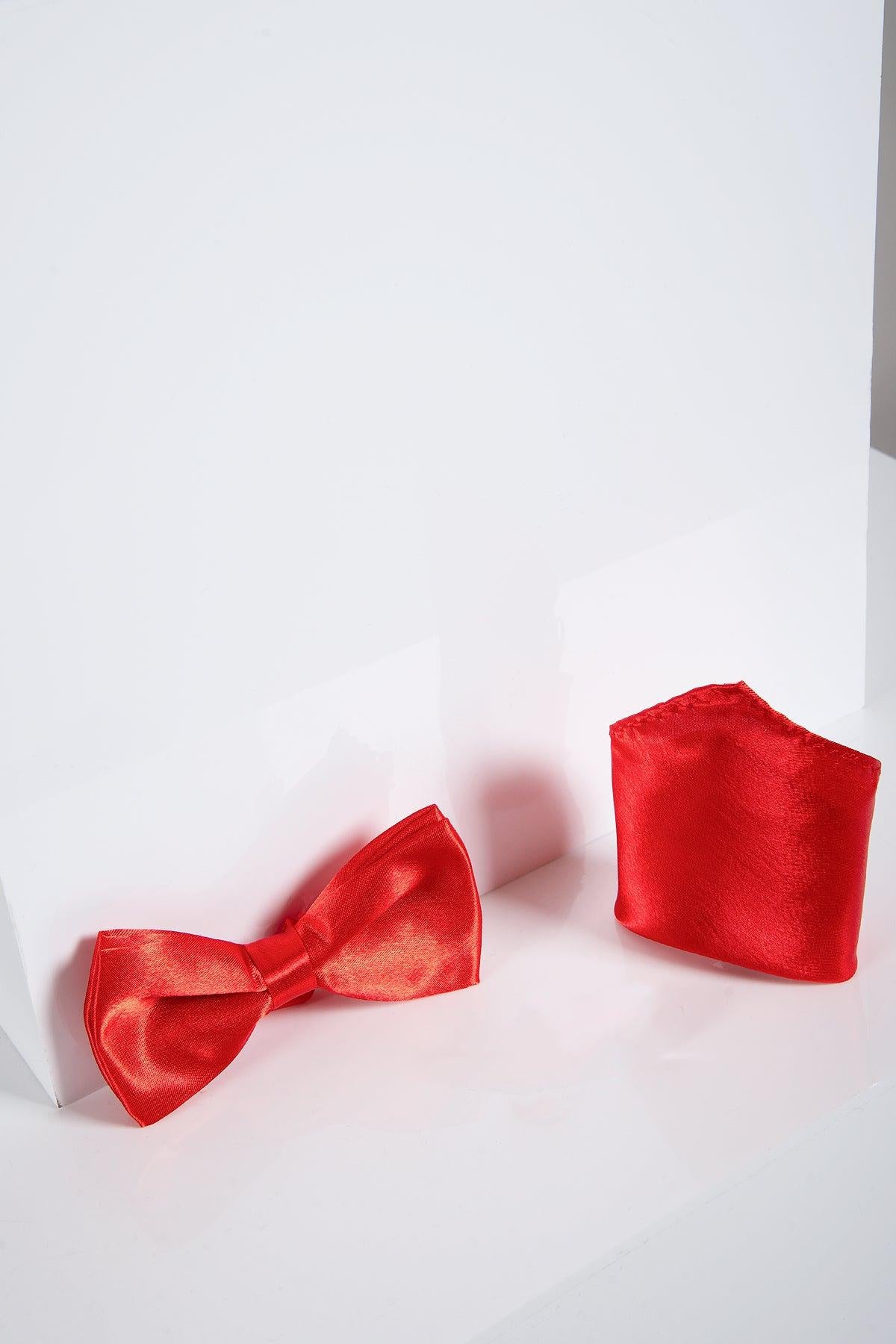 The Accessory STANLEY Satin Bow Tie and Pocket Square Set in Red includes a shiny red satin bow tie and matching pocket square, displayed on white surfaces—ideal for enhancing any formal outfit.