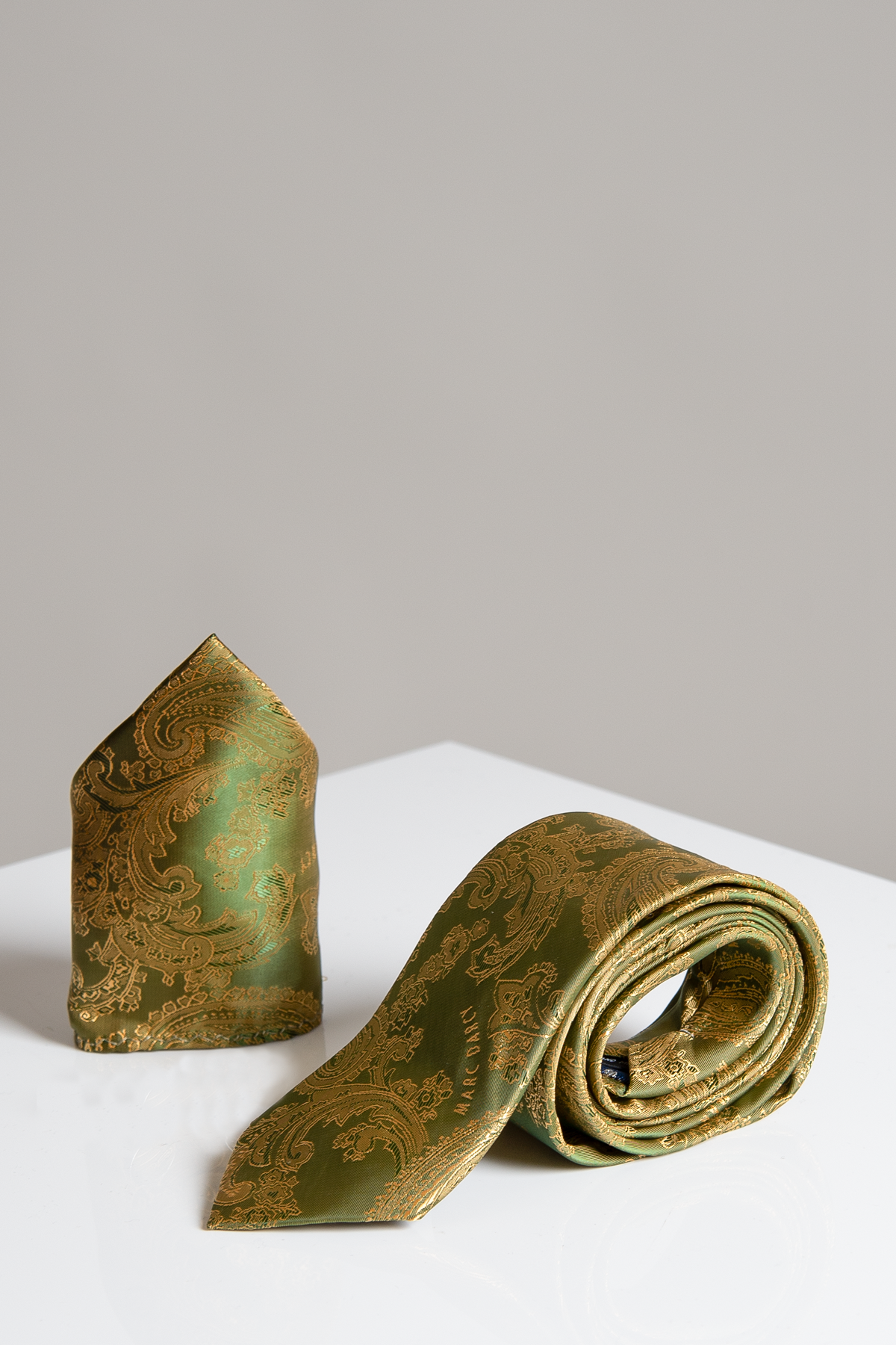 The Accessory MD PAISLEY tan paisley tie and pocket square set are displayed on a white surface with a light grey background.