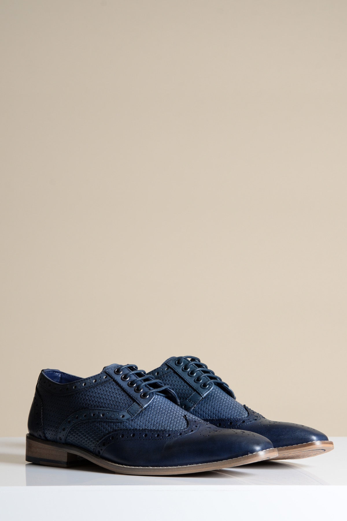 The marcdarcy BRANDON is a stylish navy blue leather wingtip brogue shoe for men, featuring intricate detailing and classic laces.