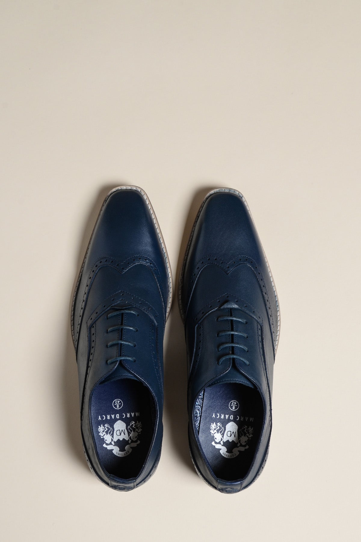 Top view of the Marc Darcy DAWSON Navy Wingtip Oxford Brogue Shoes in full grain leather, shown side by side on a light beige background.