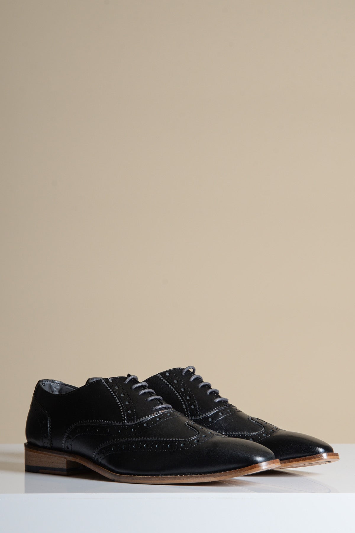 The MARCO - Black Grey Leather Wingtip Oxford Shoes by Marc Darcy feature grey laces and rest on a white surface with a neutral background.