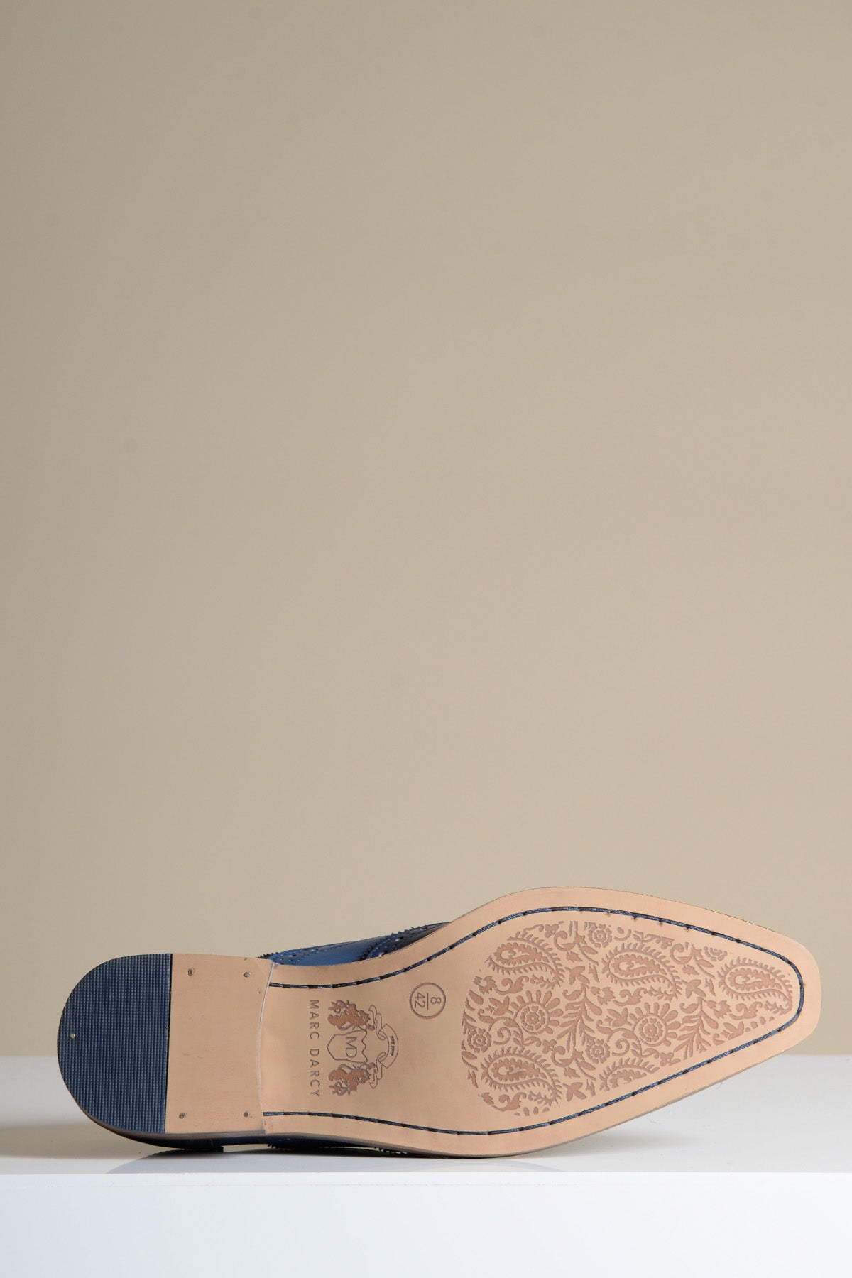 Close-up of the sole of the MARCO Navy Blue Leather Wingtip Oxford Shoe by Marc Darcy, featuring a paisley pattern, Marc Darcy branding, and classic craftsmanship.
