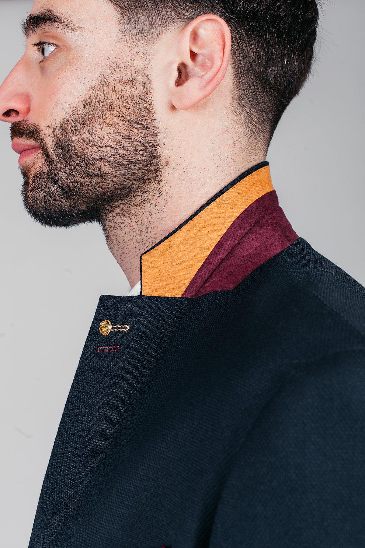 Newcastle United and England goalkeeper Nick Pope is shown in profile with a short beard, wearing the marcdarcy JD4 Navy three piece suit, distinguished by its textured fabric and accented details.