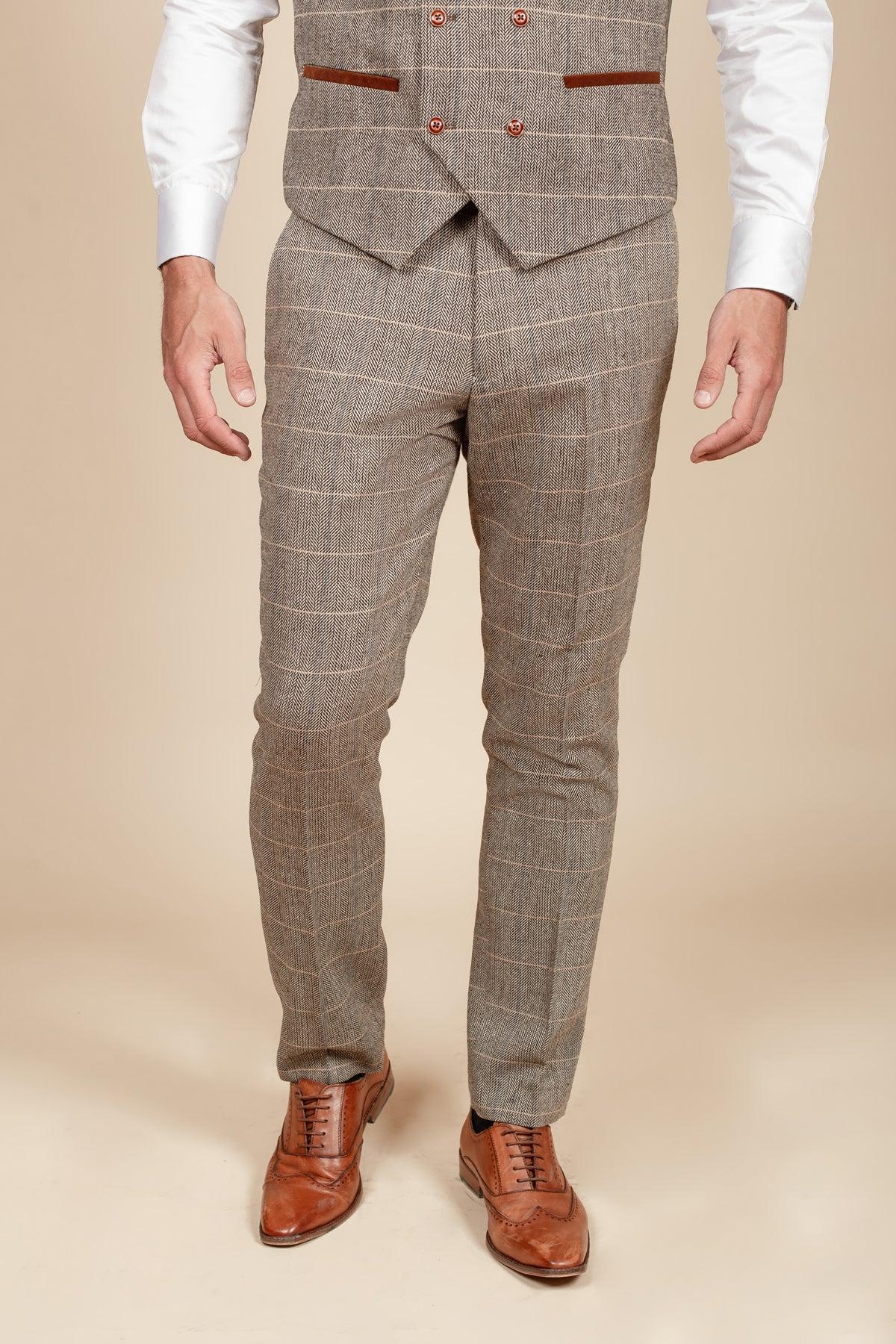 Man wearing marcdarcy’s DX7 - Tan Tweed Check Trousers with a slim fit suit, vest, white shirt, and brown dress shoes for a Peaky Blinders-inspired look.