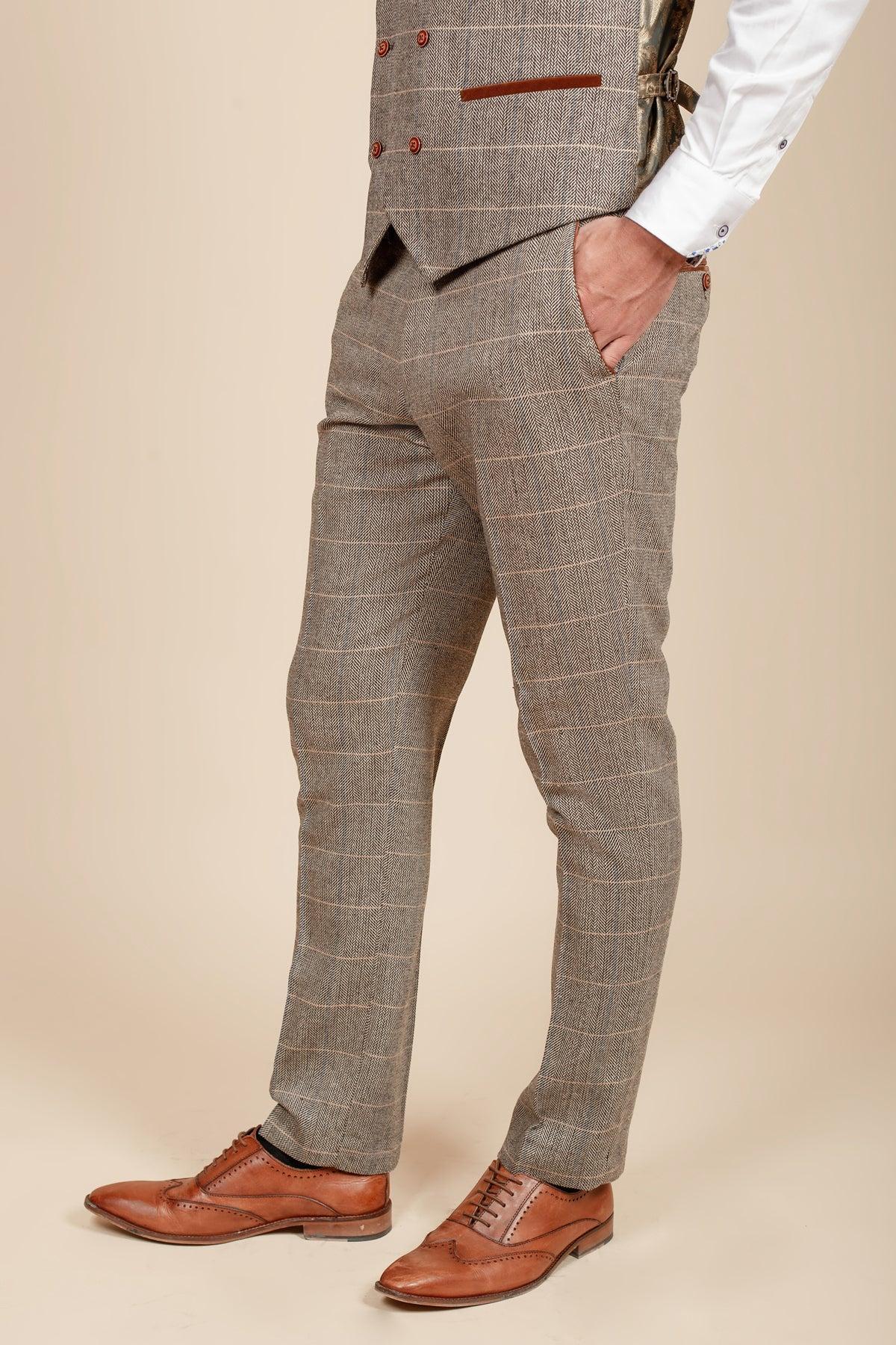 Man wears marcdarcy’s DX7 - Tan Tweed Check Trousers, styled with a white shirt and brown oxford shoes for a sharp Peaky Blinders-inspired look.