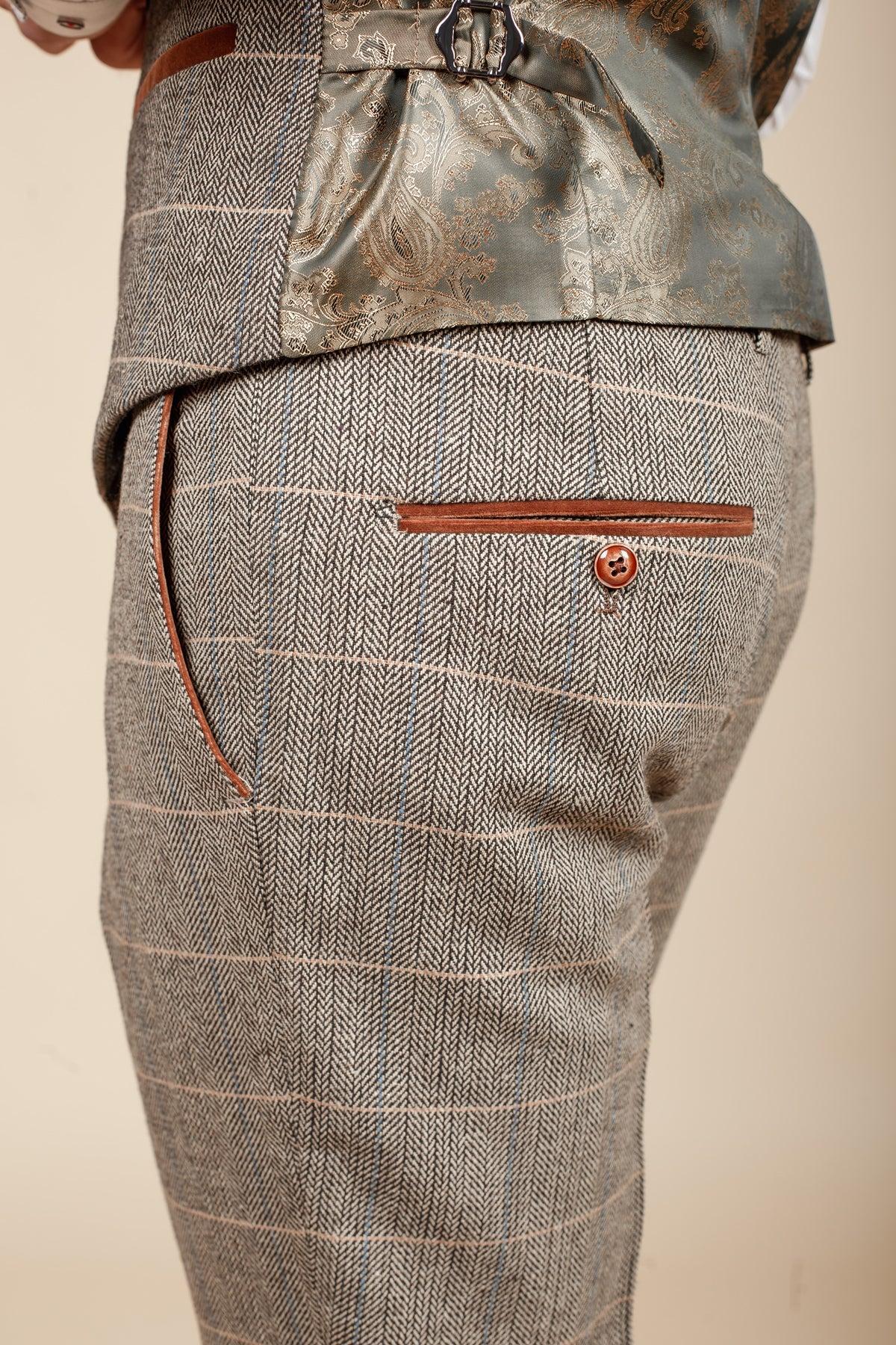 Close-up of marcdarcy DX7 - Tan Tweed Check Trousers. Features a slim fit, brown leather-trimmed back pocket with button, and a vintage plaid pattern with pink and blue lines for a classic Peaky Blinders look.