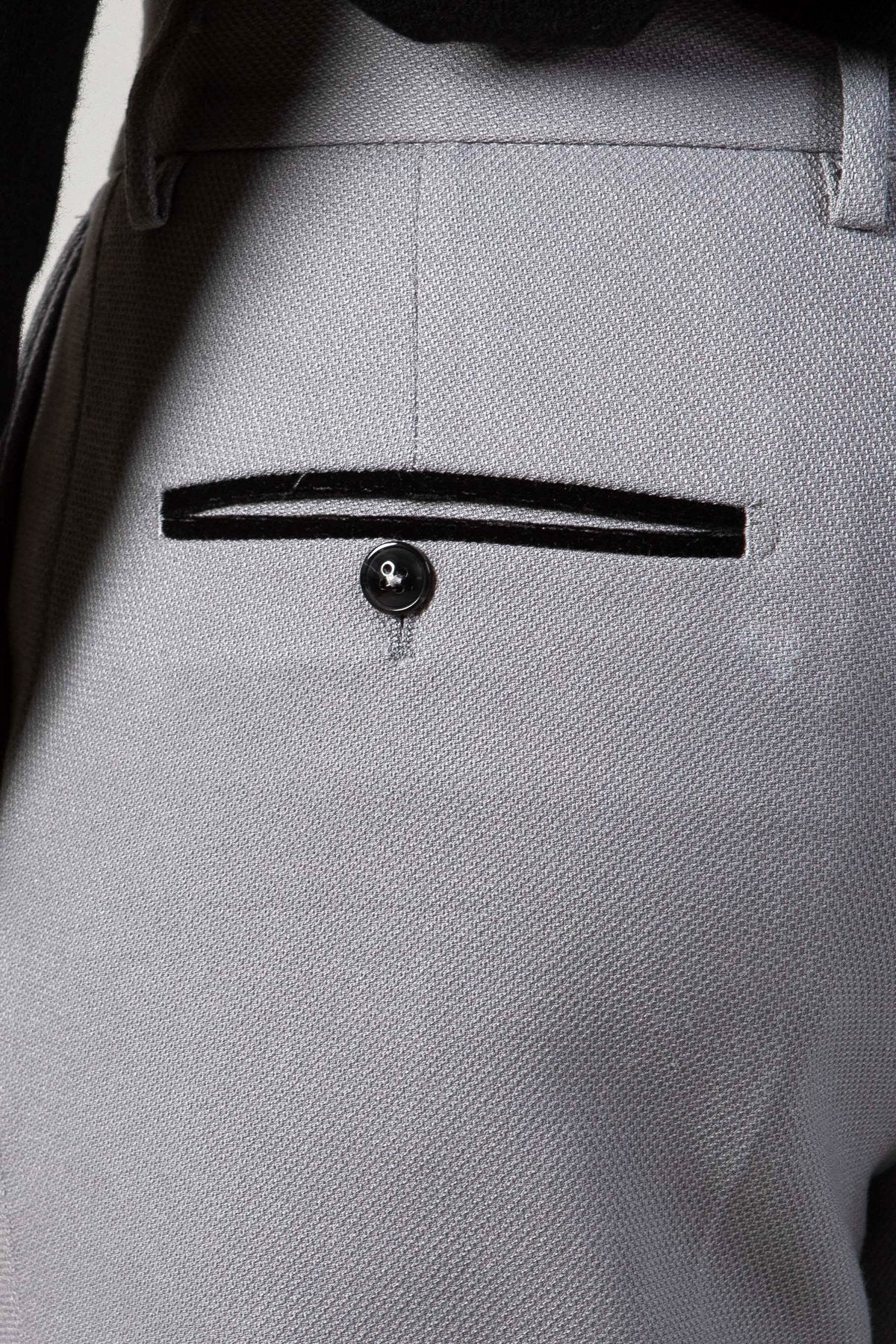 Close-up of the back pocket on marcdarcy’s EDWIN Silver Grey Notch Lapel Three Piece Suit, featuring a single button, black trim detail, and visible fabric texture that enhances its sharp tailored look.