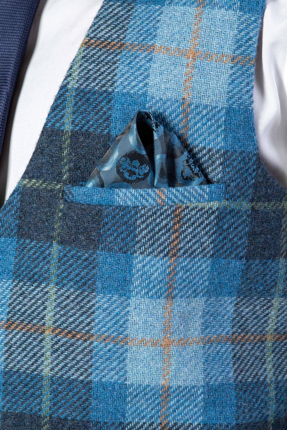 The Marc Darcy MORRIS Blue Tweed Check Waistcoat in modern tailoring is paired with a patterned blue pocket square.