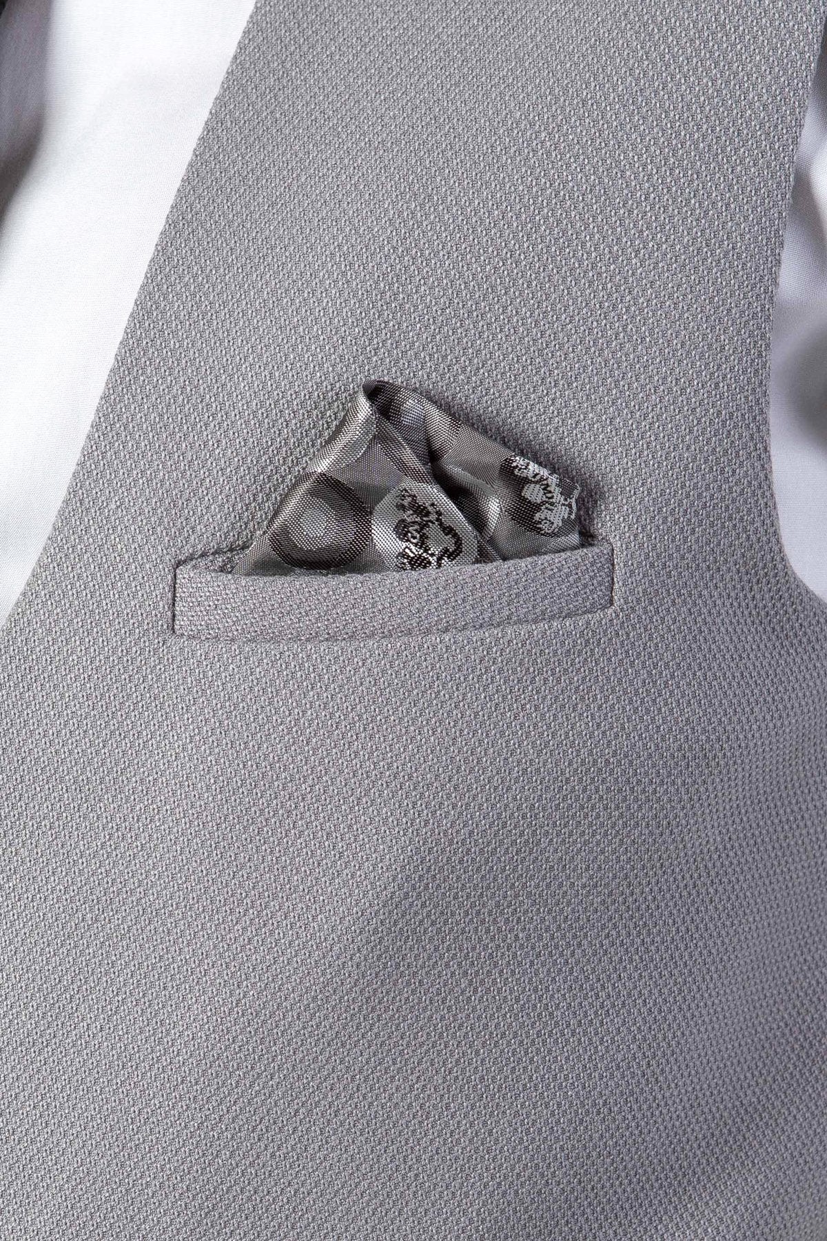 Close-up of a marcdarcy EDWIN Silver Grey Notch Lapel Three Piece Suit vest, featuring textured fabric and a patterned pocket square in the breast pocket.