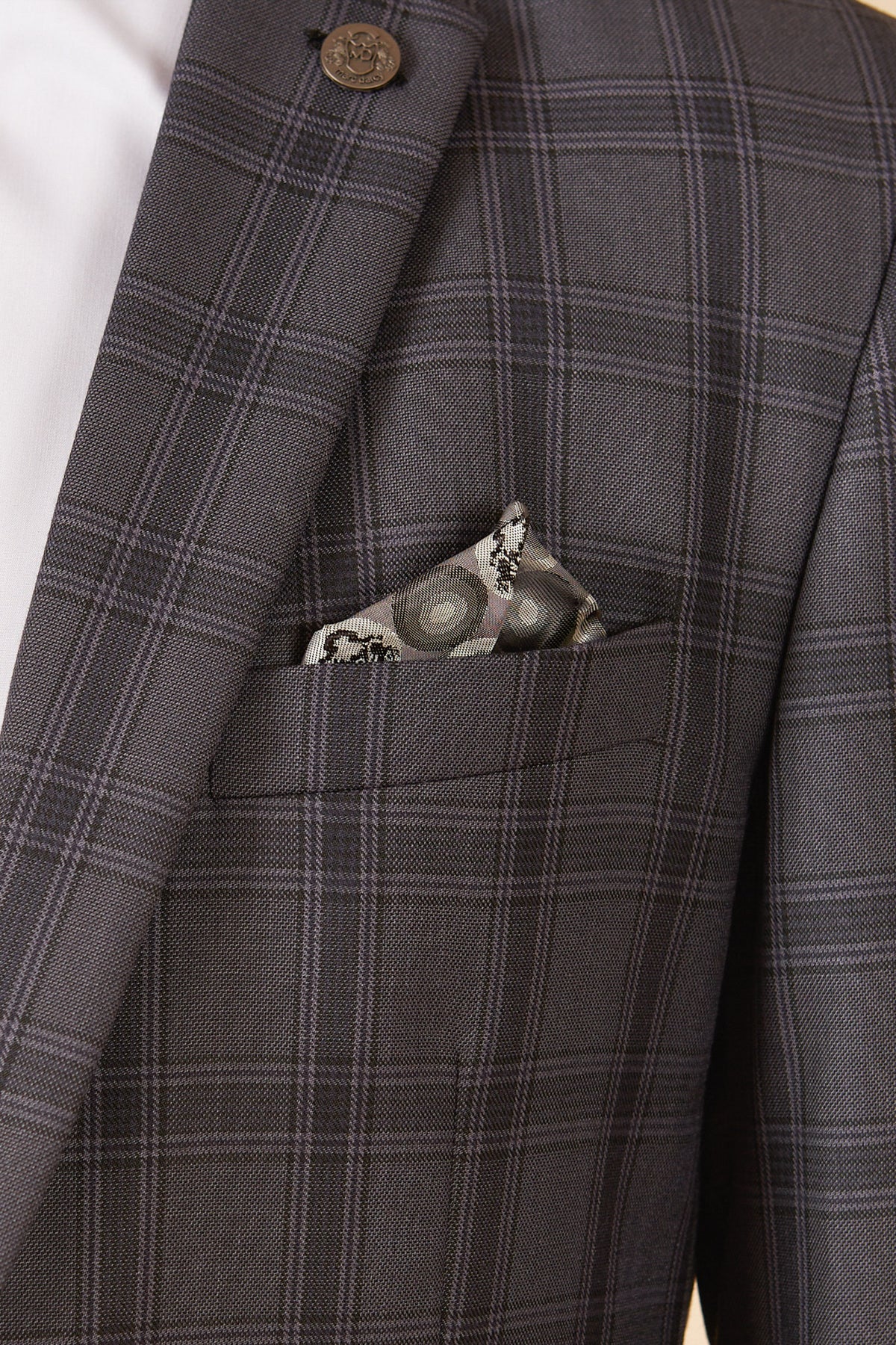 Close-up of a man wearing the marcdarcy JOSE - Grey Check Three Piece Suit, featuring a tailored fit jacket with decorative button, white shirt, and a patterned pocket square in the breast pocket.