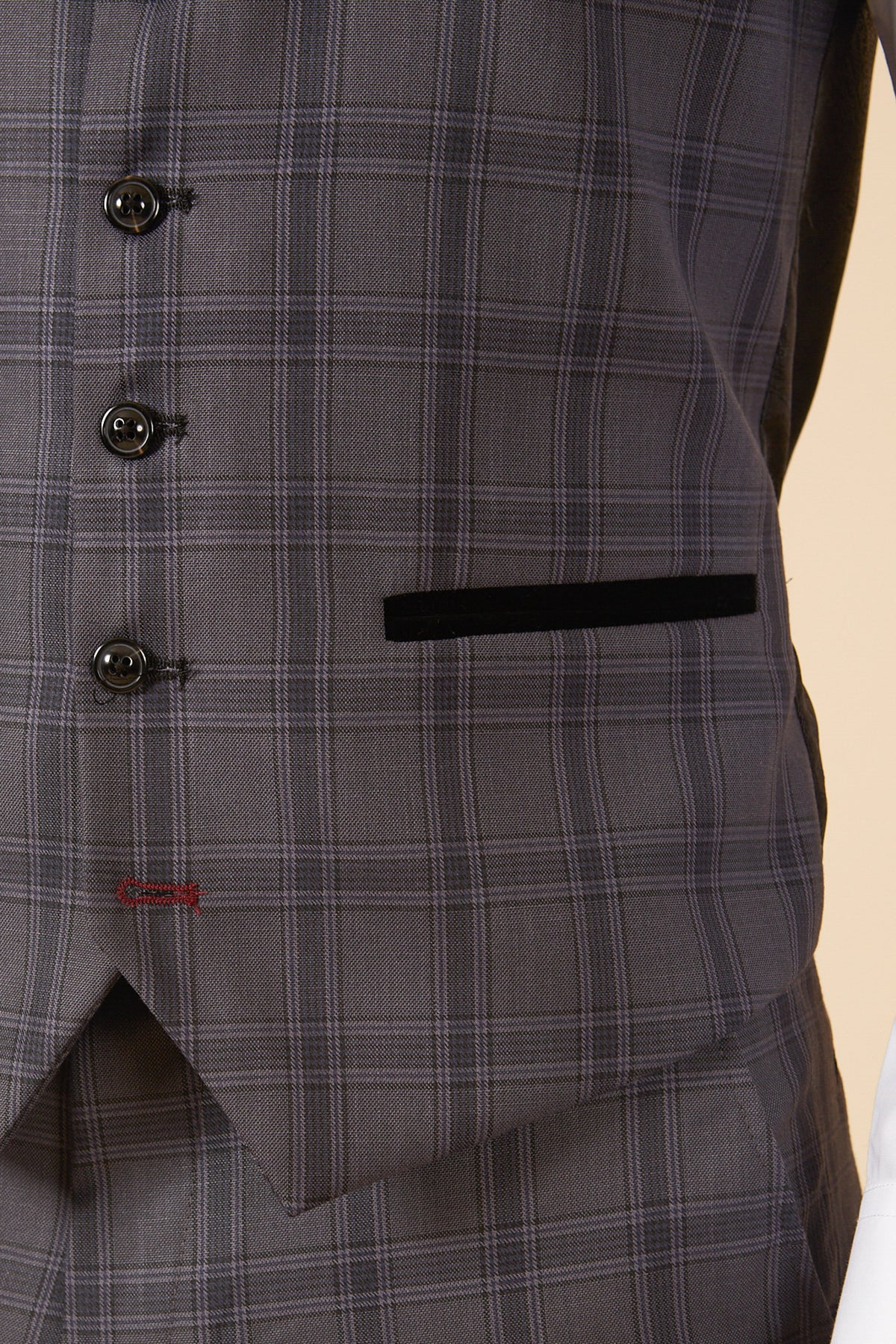Close-up of the marcdarcy JOSE Grey Check Single Breasted Waistcoat, featuring black buttons and a black-trimmed pocket. A white shirt sleeve appears on the right.