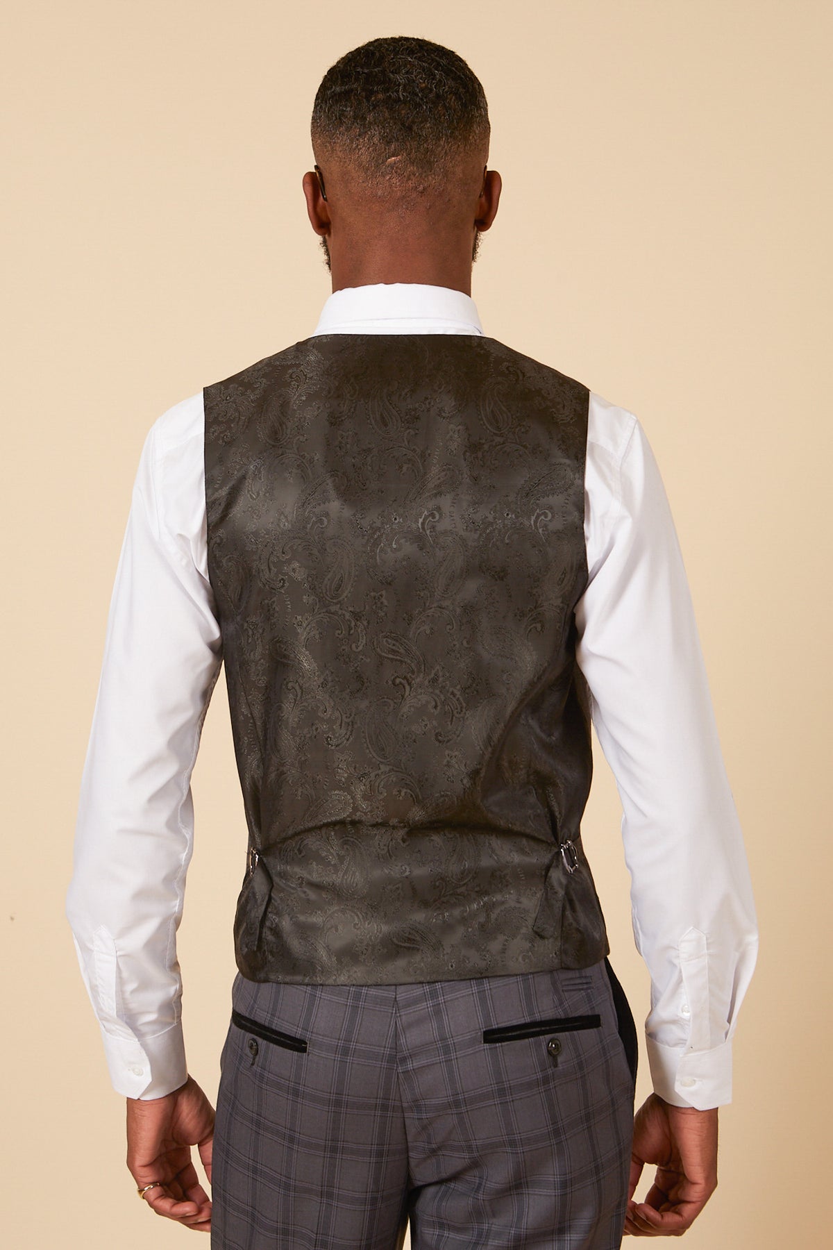 Back view of a man wearing the marcdarcy JOSE Grey Check Single Breasted Waistcoat over a white shirt and gray plaid pants.