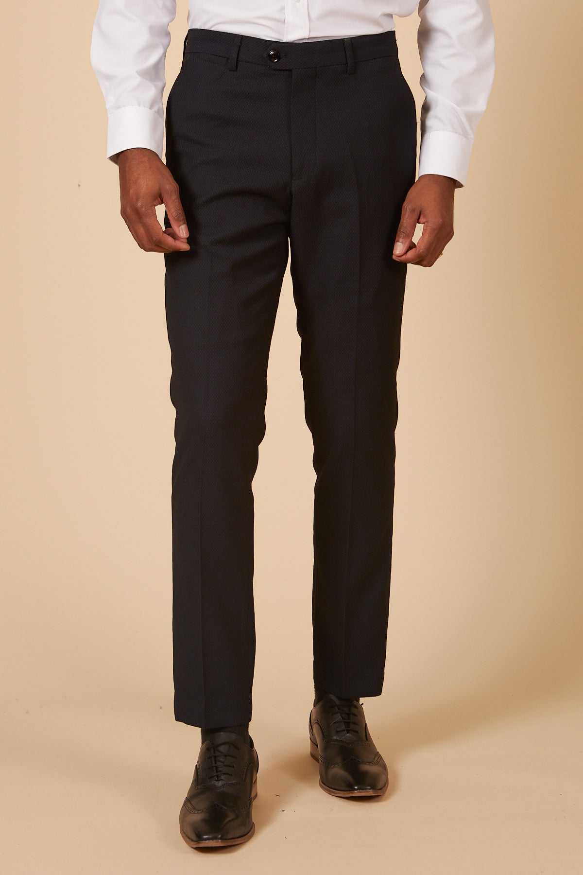 A person wearing the marcdarcy DALTON - Navy Tux Lapel Diamond Three Piece Suit stands against a plain beige background. The image is cropped from the chest down.