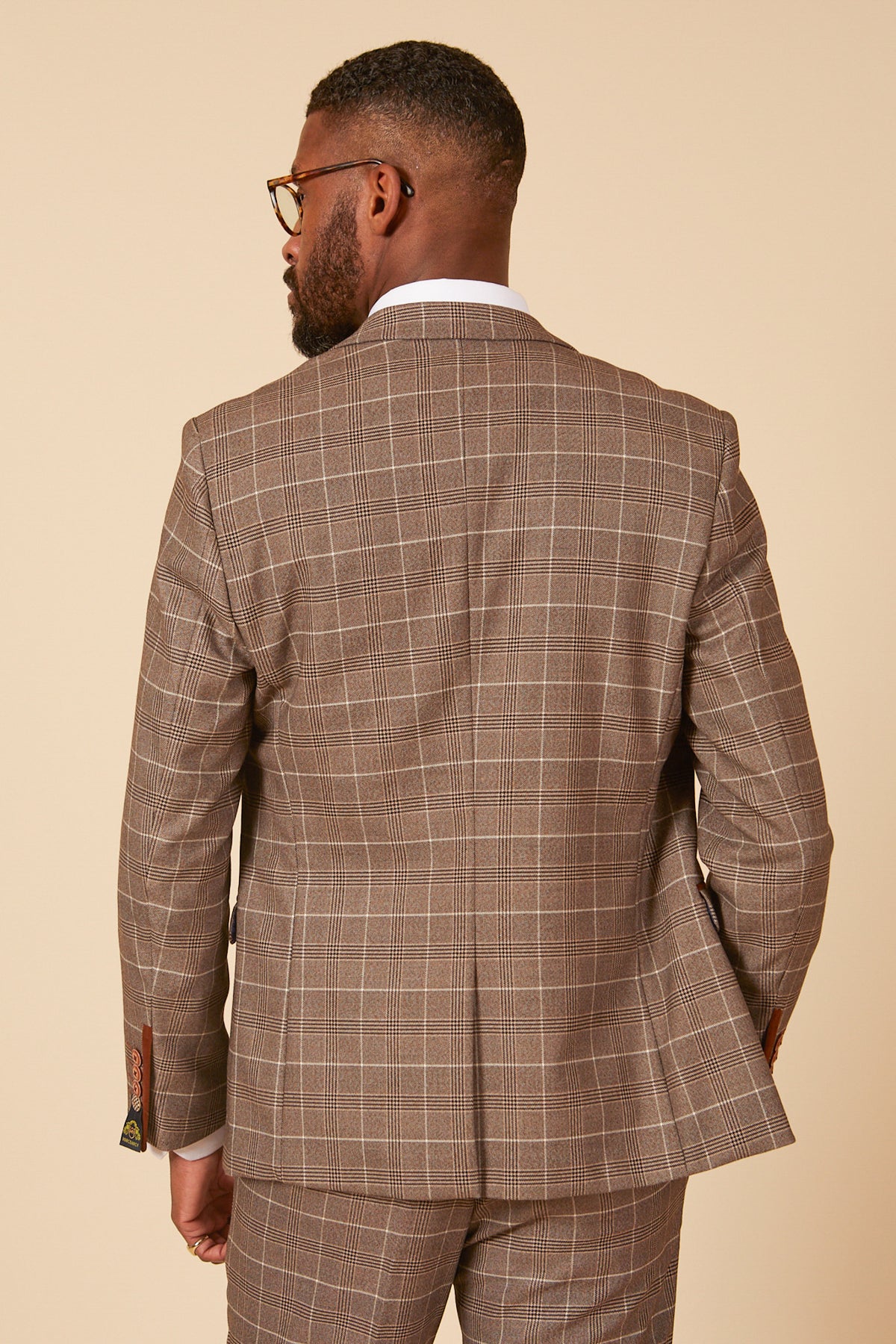 A man wearing the marcdarcy RAY Tan Check Blazer and glasses is shown from the back.