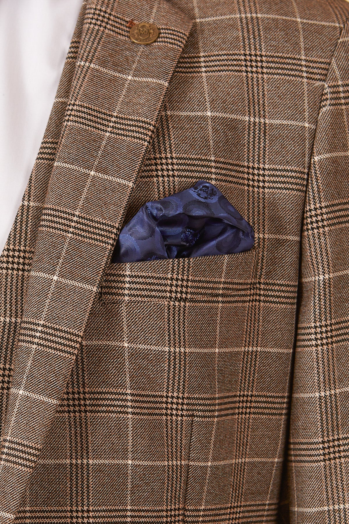 A close-up of the marcdarcy RAY - Tan Check Blazer featuring a blue silk pocket square in the breast pocket and a white shirt underneath.