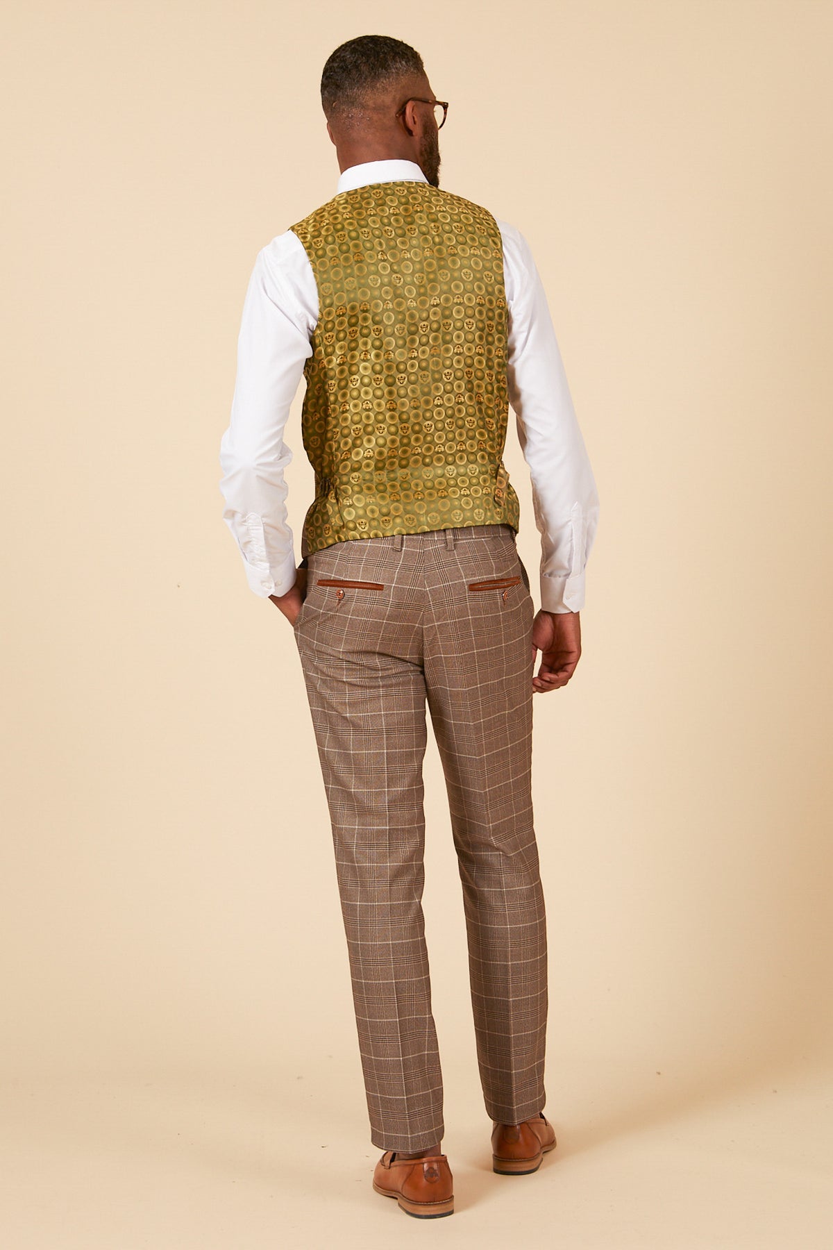 Man wearing a white shirt, marcdarcy RAY tan check waistcoat, and brown plaid pants.