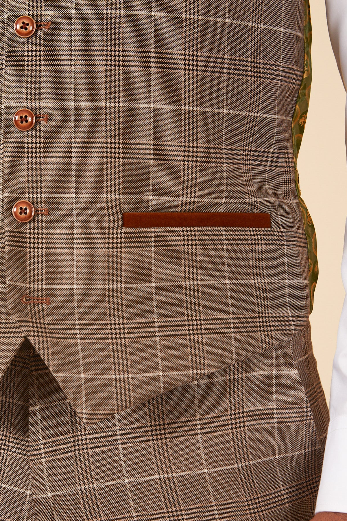 Close-up of a person wearing the marcdarcy RAY Tan Check Waistcoat, featuring matching pockets and buttons, paired with plaid trousers and a visible white shirt sleeve.