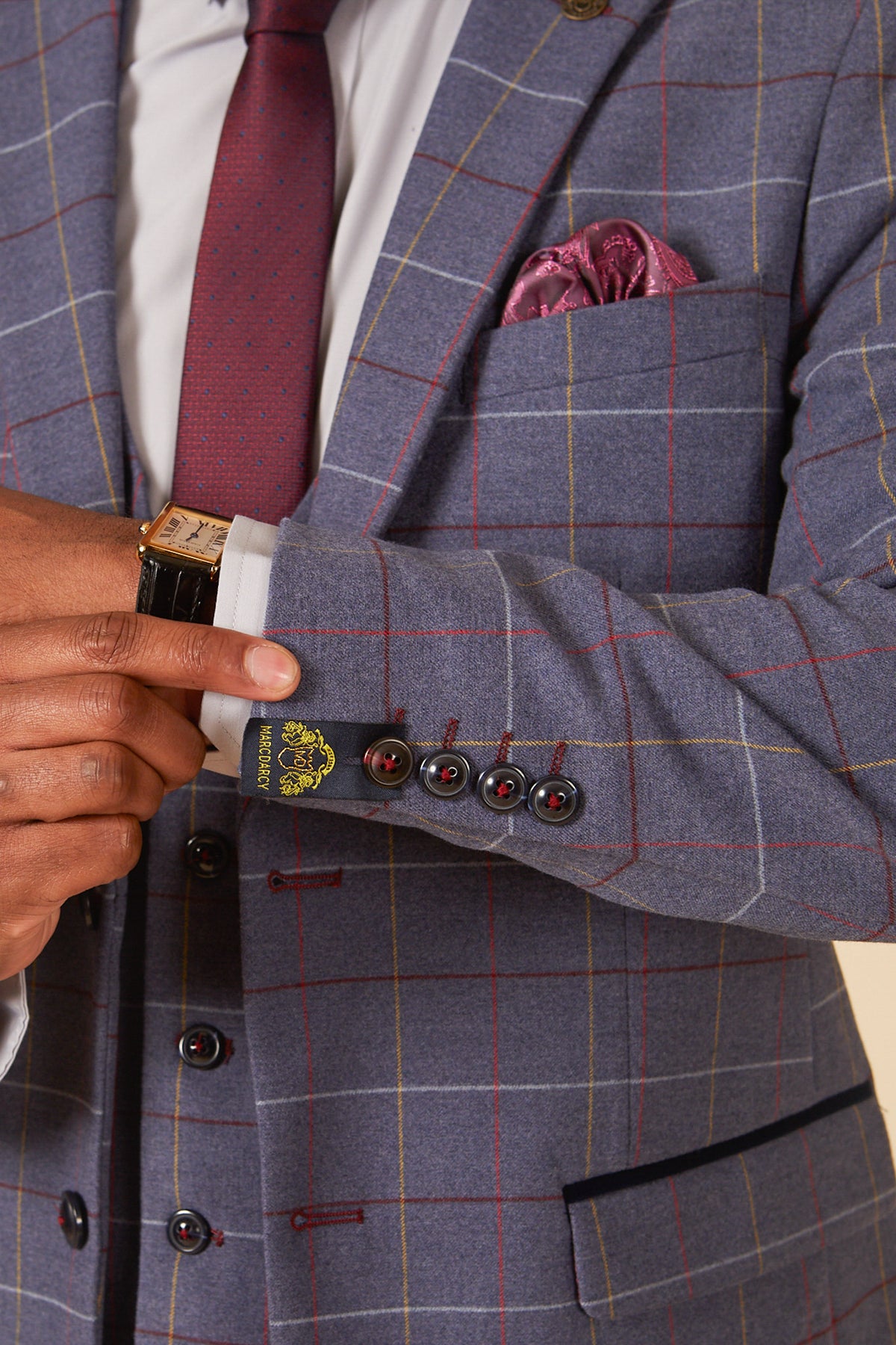 Man wearing the marcdarcy DRAKE Sky Blue Check Three Piece Suit with a red polka dot tie, red paisley pocket square, and a gold watch visible on his wrist.