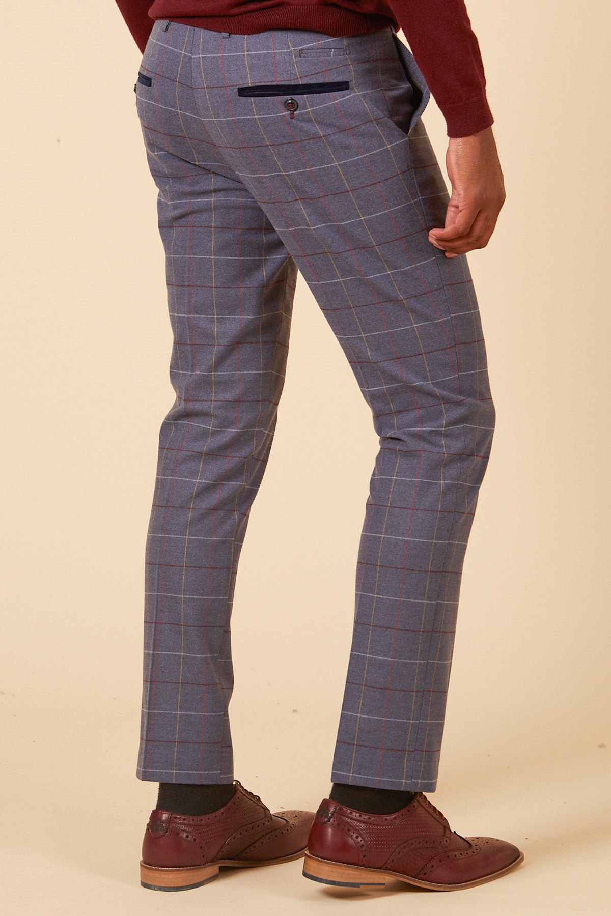 A person wearing the marcdarcy DRAKE - Sky Blue Check Three Piece Suit stands on a beige background, styled for a formal occasion and viewed from the back.
